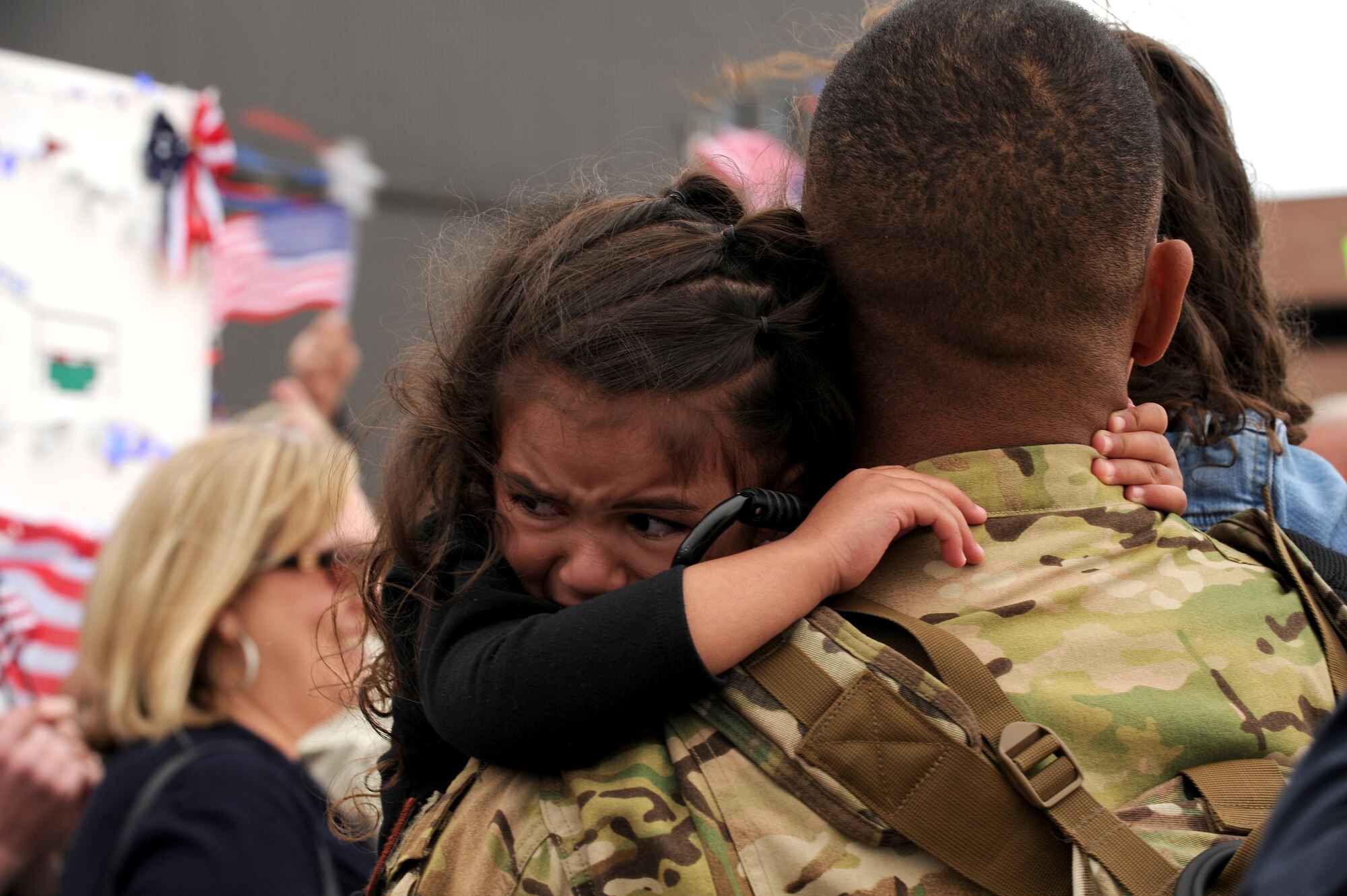 A young daughter is overcome with emotion as she hugs her father upon his return after he returned from a four-month deployment on May 18, 2016 at Peterson Air Force Base, Colo. Approximately 150 Air Force Reservists and four C-130 cargo aircraft from the 302nd Airlift Wing returned home from Al Udeid Air Base, Qatar, in support of Operations Freedom’s Sentinel and Inherent Resolve. While deployed, the Airmen provided critical C-130 airlift support to include airlift, airdrop and aeromedical evacuation to U.S. Central Command operations throughout Southwest Asia. The deployed members of the 302nd Maintenance Group provided aircraft maintenance support ensuring fully mission capable C-130s in Southwest Asia.  (U.S. Air Force photo/Staff Sgt. Amber Sorsek)