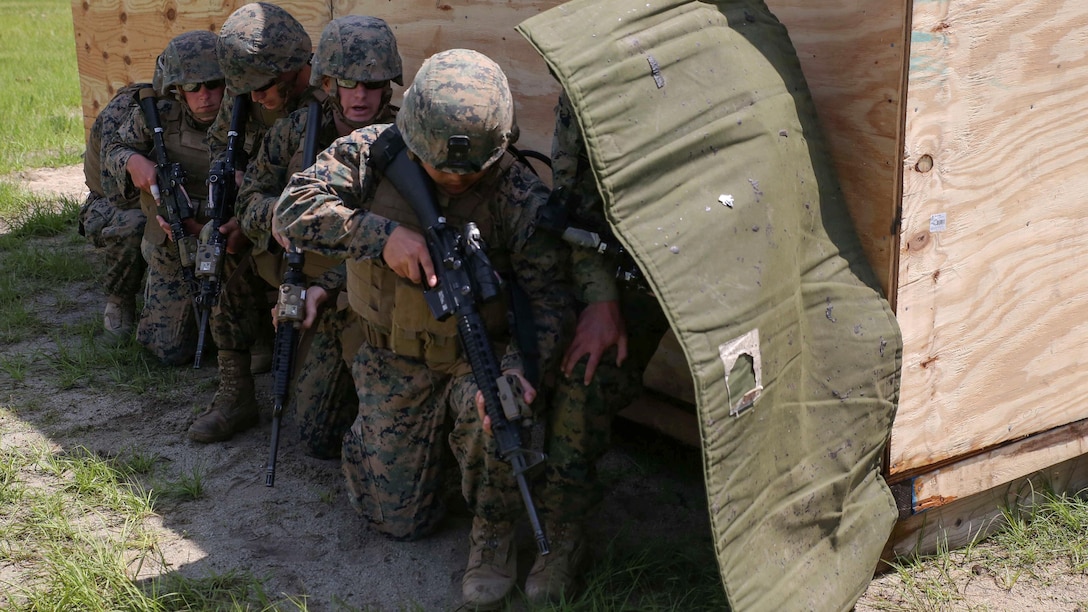 Marines with 2nd Combat Engineer Battalion brace themselves before detonating a charge during breaching operations at Marine Corps Base Camp Lejeune, North Carolina, May 19, 2016. The unit built, placed, and detonated charges to practice gaining entry and clearing an enemy-occupied building in preparation for an upcoming deployment.