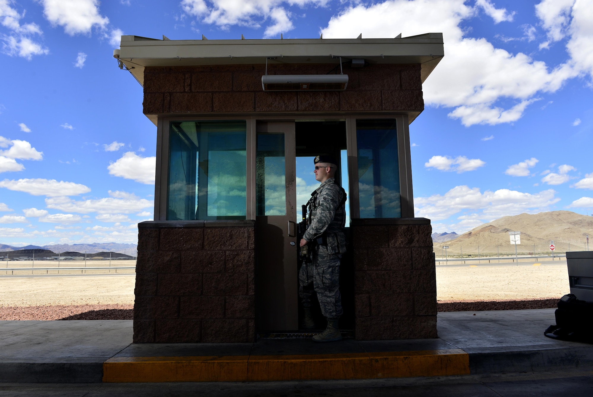 Airman 1st Class Elijah, 799th Security Forces Squadron security forces member, stands guard at the base entry control center May 16, 2016, at Creech Air Force Base, Nevada. National Police Week takes place annually to honor the service and sacrifice of civilian and military law enforcement members. (U.S. Air Force photo by Senior Airman Christian Clausen/Released)