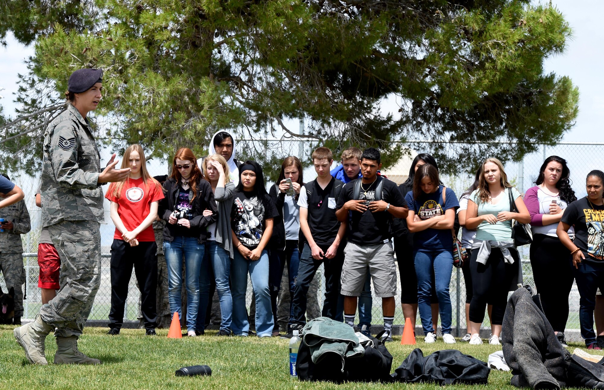 Tech. Sgt. Christine, 799th Security Forces Squadron kennel master, explains the safety procedures during a K-9 demonstration to children at a local high school on May 17, 2016, in Indian Springs, Nevada. The demonstration was part of National Police Week, an observance which honors civilian and military law enforcement members who have paid the ultimate sacrifice. (U.S. Air Force photo by Senior Airman Adarius Petty/Released)