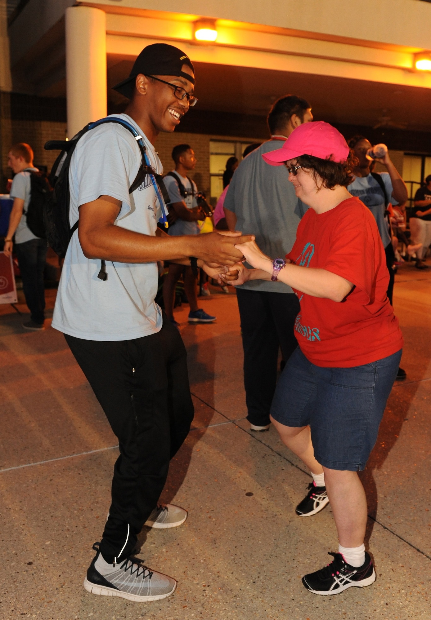 Airman Marcus Houston, 336th Training Squadron student, dances with Mary Wilson, Special Olympics athlete, at the Special Olympics Mississippi Summer Games closing ceremonies at the triangle area May 21, 2016, Keesler Air Force Base, Miss. This is the 30th year Keesler has hosted the state Special Olympics.  (U.S. Air Force photo by Kemberly Groue)