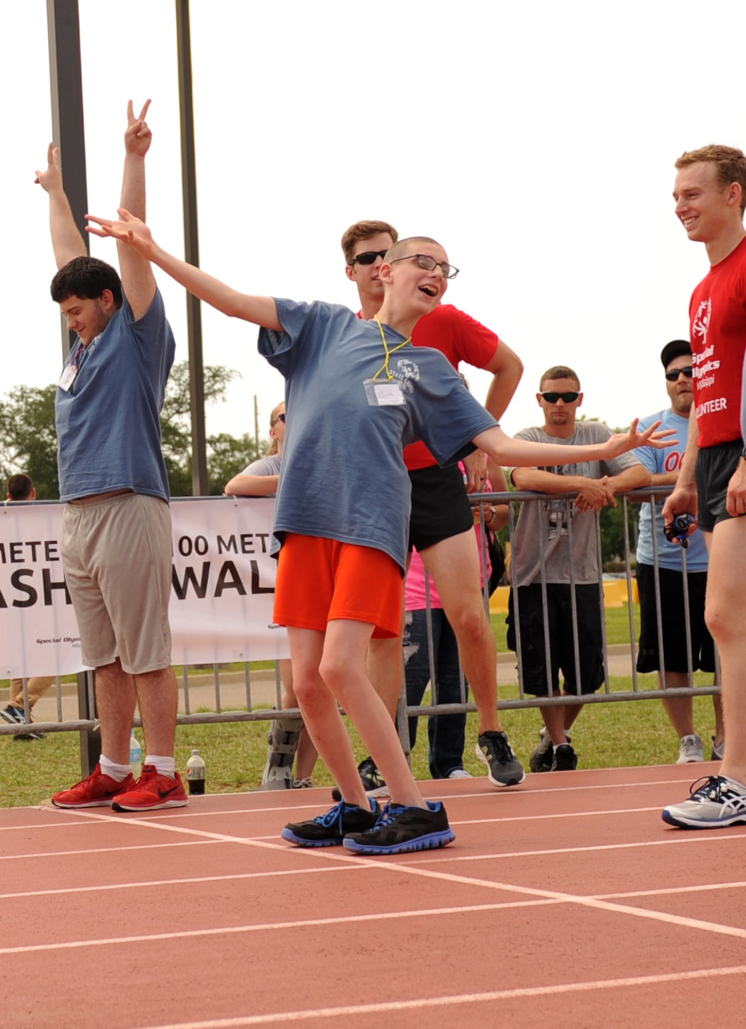 Athletes react to the announcement of their names at the track events during the Special Olympics Mississippi Summer Games at the triangle track May 21, 2016, Keesler Air Force Base, Miss. More than 700 athletes and 3,000 volunteers worked together to hold competitions throughout the day. This is the 30th year Keesler has hosted the state Special Olympics.  (U.S. Air Force photo by Kemberly Groue)