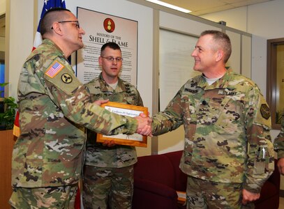 Col. Lawrence Leon, commander 3rd Ordnance Brigade 94th Training Division, thanks Lt. Col. James A. Parkinson, deputy garrison commander, Fort McCoy Wis., for his role in supporting the ammunition specialist reclassification course transition from Ft. Lee, Va., to Fort McCoy. Leon also presented Parkinson with his commander’s coin and a certificate of appreciation during an impromptu ceremony at Fort McCoy, May 13, 2016. Parkinson lead all the in progress reviews while the transition was being planned. The 94th Training Division will begin the phased move of Ammunition Stock Control and Accounting Specialist, Ammunition Specialist, courses to Fort McCoy for the start of FY17.