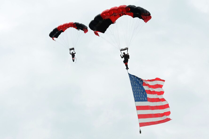 Members of the U.S. Army Special Operations Command Parachute Demonstration Team fly in the American flag, officially beginning the second day of the 2016 Shaw Air Expo and open house, “Thunder Over the Midlands,” at Shaw Air Force Base, S.C., May 22. The Black Daggers perform live aerial demonstrations in support of U.S. Army special operations community relations and recruiting. 