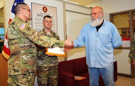 Col. Lawrence Leon, commander 3rd Ordnance Brigade 94th Training Division, thanks Scott Humberg for his role in supporting the ammunition specialist reclassification course transition from Ft. Lee, Va., to Fort McCoy. Leon also presented Humberg with his commander’s coin and a certificate of appreciation during an impromptu ceremony at Fort McCoy,Wis., May 13, 2016. The 94th Training Division will begin the phased move of Ammunition Stock Control and Accounting Specialist, Ammunition Specialist, courses to Fort McCoy for the start of FY17.