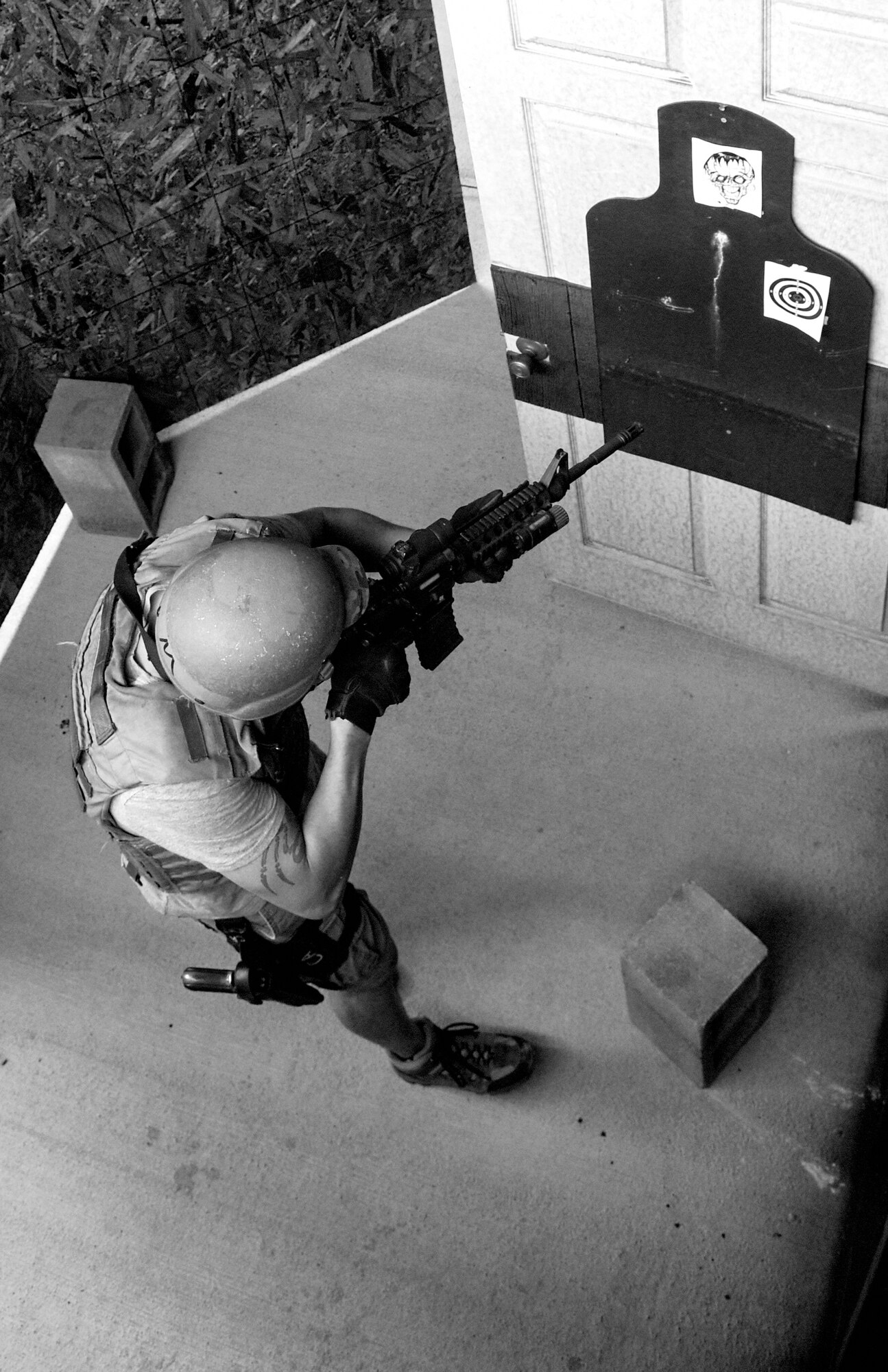 An Airman from the 4th Security Forces Squadron targets a simulated enemy combatant during a shoot competition, May 17, 2016, at Seymour Johnson Air Force Base, North Carolina. Seven two-man teams from the 4th SFS and the 4th Civil Engineer Squadron explosive ordnance disposal flight competed against one another in a shoot competition at the Urban Tactical Training Area as part of Police Week events held on base. (U.S. Air Force photo by Airman Shawna L. Keyes/Released)