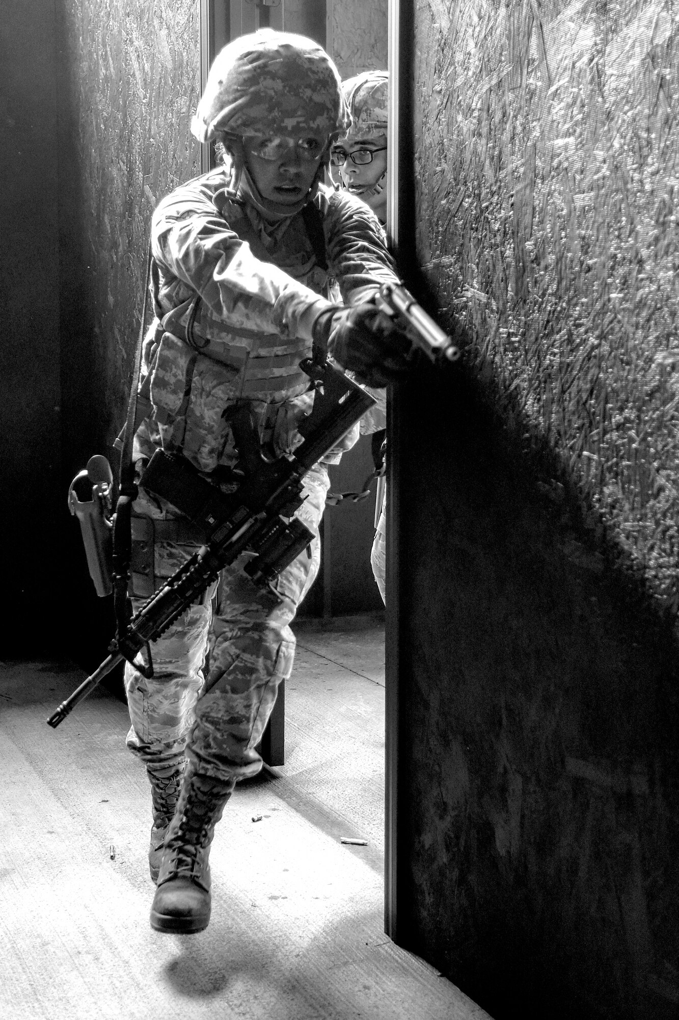 Airman Mia Rus, 4th Security Forces Squadron defender, leaves from a cleared room during a shoot competition, May 17, 2016, at Seymour Johnson Air Force Base, North Carolina. Airmen from the 4th SFS and 4th Civil Engineer Squadron explosive ordnance disposal flight participated in the shoot competition as part of events held in honor of Police Week. (U.S. Air Force photo by Airman Shawna L. Keyes/Released)