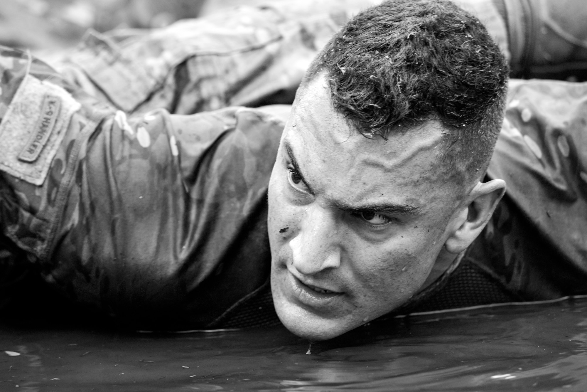 Staff Sgt. Barton Gonzales, 4th Security Forces Squadron military working dog handler, prepares to do a push-up square during a pain challenge, May 19, 2016, at Seymour Johnson Air Force Base, North Carolina. Teams of four competed in the challenge as part of Police Week. (U.S. Air Force photo by Airman Shawna L. Keyes/Released)