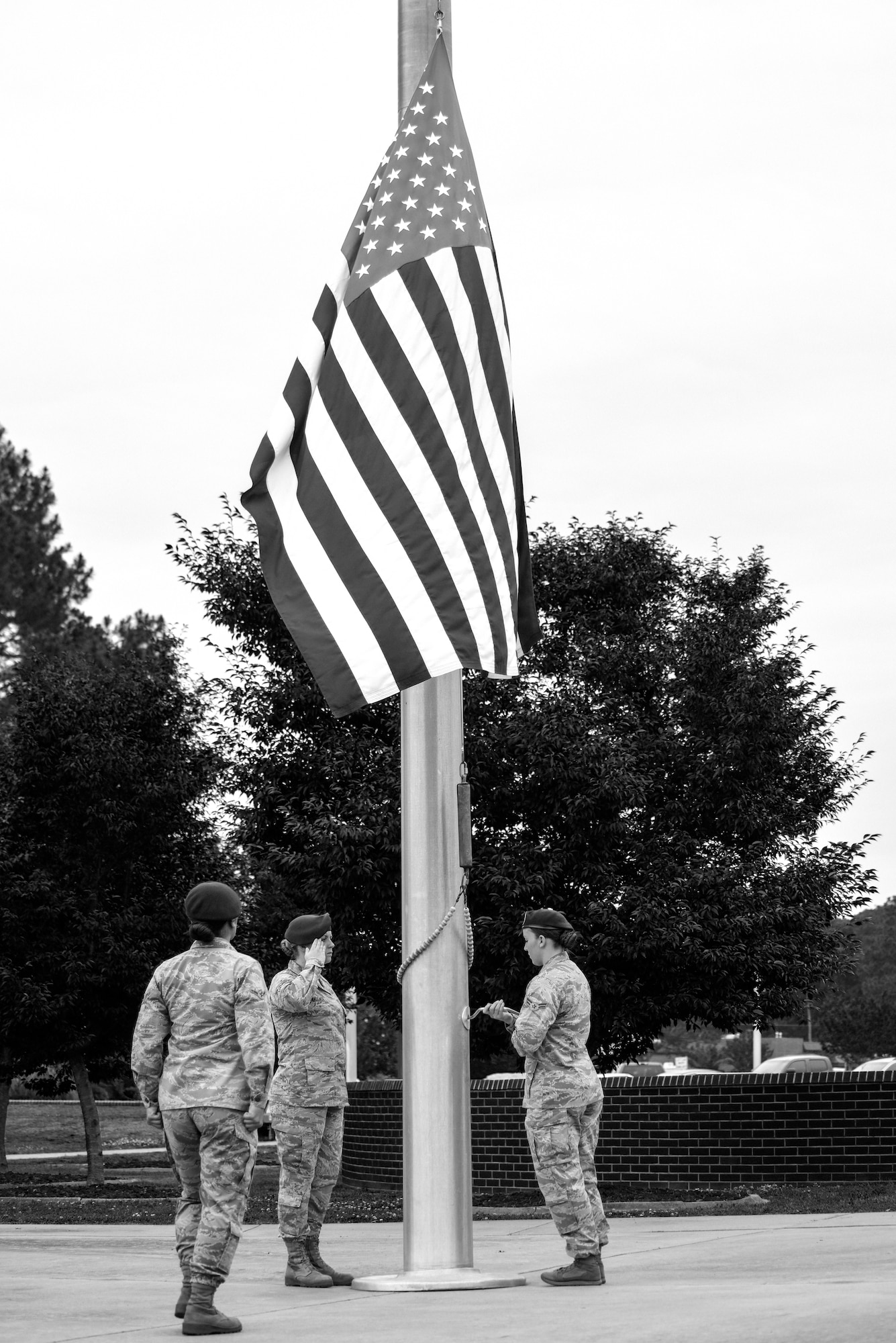 Airmen from the 4th Security Forces Squadron lower the U.S. flag during retreat at the Police Week closing ceremony, May 20, 2016, at Seymour Johnson Air Force Base, North Carolina. During retreat, Airmen remembered 4th SFS and Detachment 216 Air Force Office of Special Investigations members who gave the ultimate sacrifice. (U.S. Air Force photo by Airman Shawna L. Keyes/Released) 