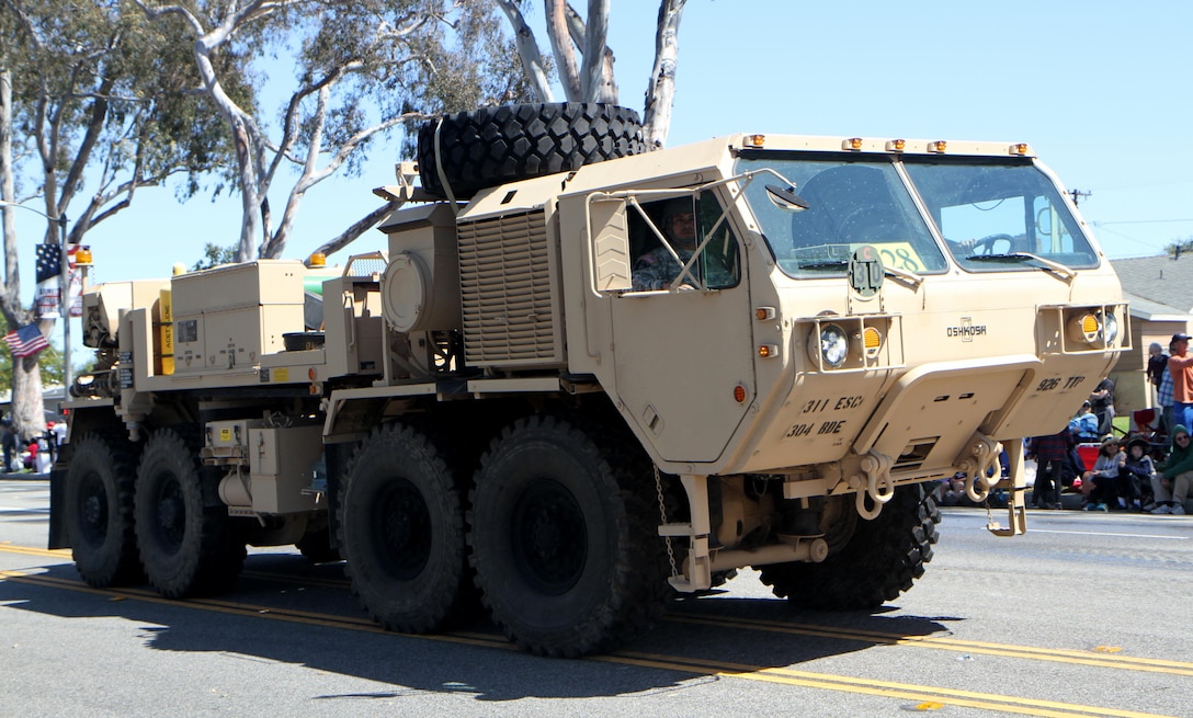 A Heavy Expanded Mobility Tactical Truck wrecker from the 311th Expeditionary Sustainment Command from Los Angeles, Calif., drives down Torrance Boulevard in Torrance, Calif., May 21, 2016, during the Torrance Armed Forces Day Parade. The parade is longest running of its kind; 2016 marking its 57th year. The wrecker is equipped with a recovery winch vehicle retrieval system.