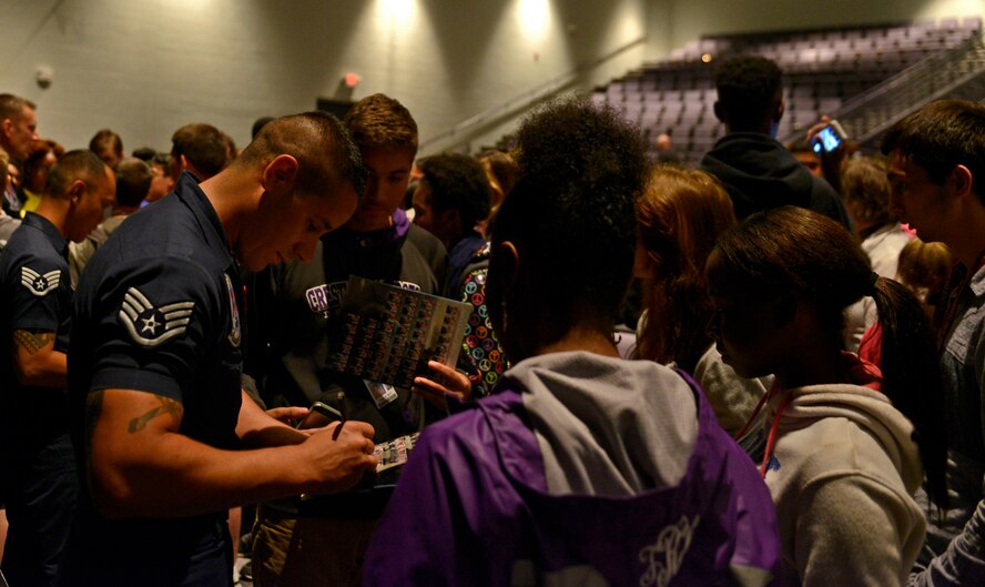 A member of the U.S. Air Force Demonstration Squadron signs autographs during a school visit at Crestwood High School, Sumter S.C., May 20, 2016. Students had the opportunity to talk face-to-face with the Thunderbirds team members and pilots throughout the duration of the school visits. The Thunderbirds showcase the pride, precision, and professionalism of American Airmen both in the air and on the ground. 