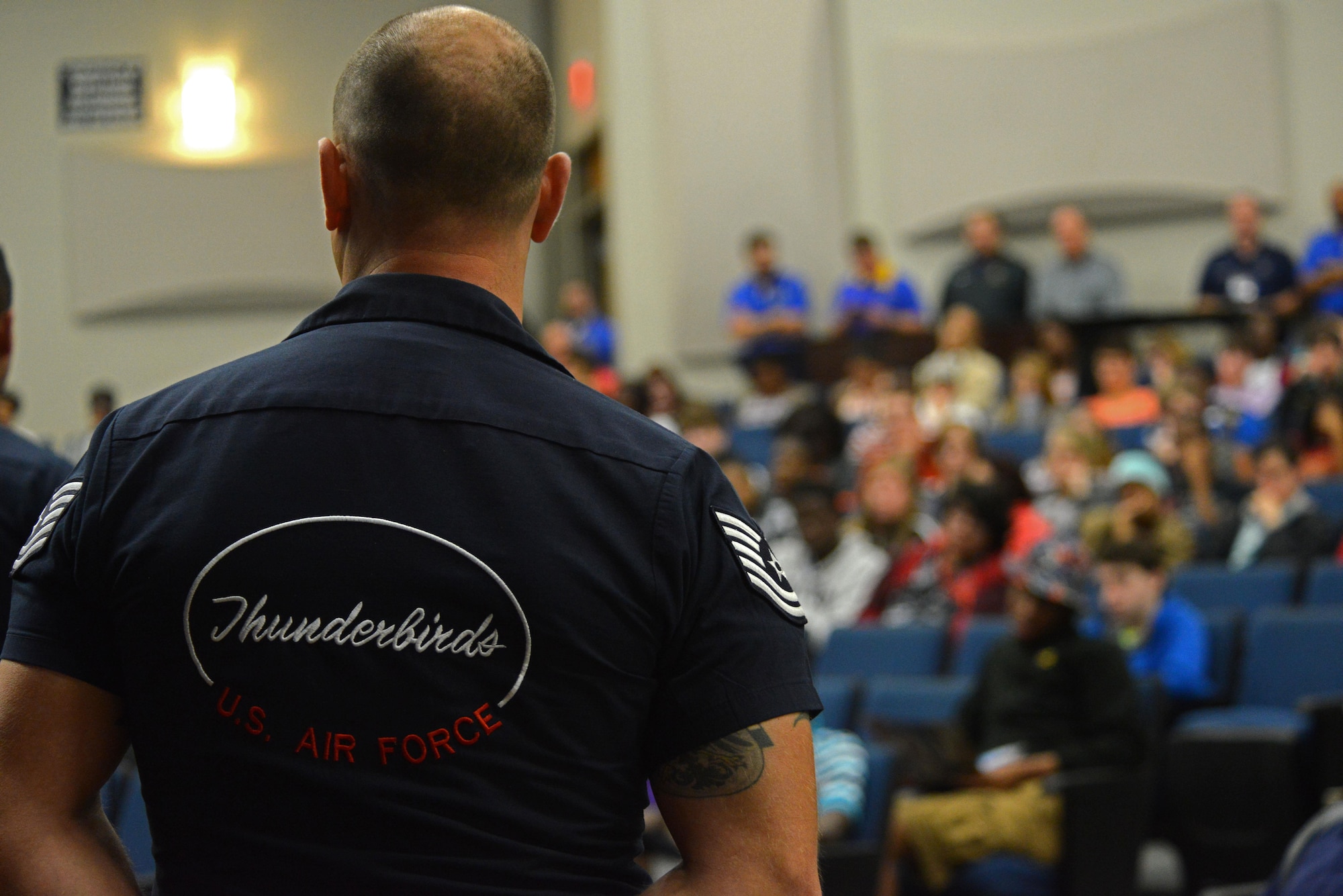 A member of the U.S. Air Force Demonstration Squadron, the Thunderbirds, speaks with students from Sumter High School, Sumter S.C., during a school visit, May 20, 2016. The Thunderbirds pilots and their team members talked to students about their jobs and gave advice about joining the Air Force. 