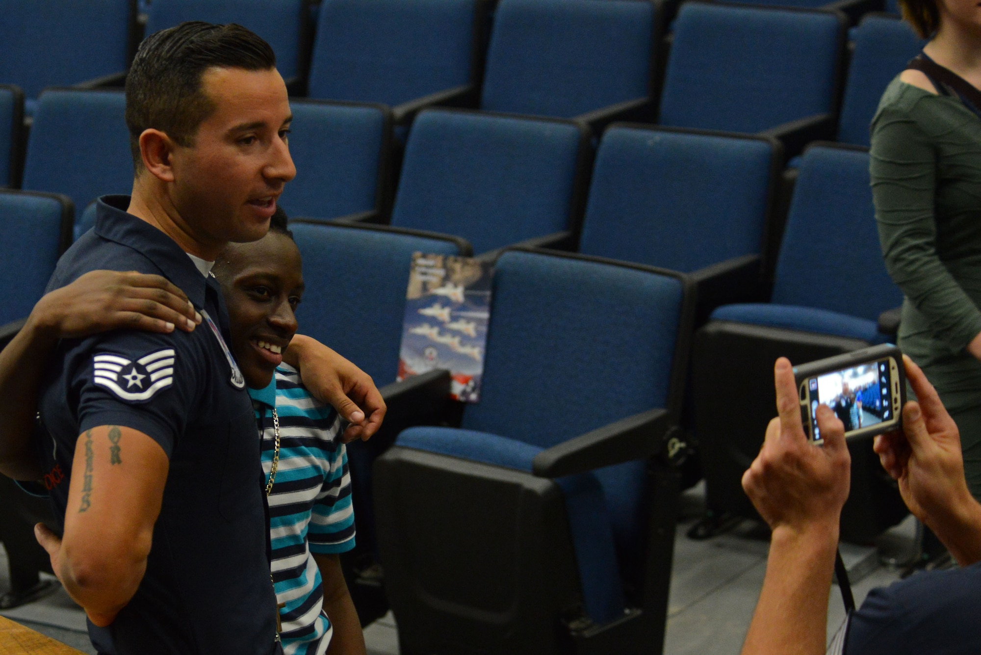 A member of the U.S. Air Force Demonstration Squadron takes a photo with a student during a Thunderbirds school visit to Sumter High School, Sumter S.C., May 20, 2016. The Thunderbirds team is comprised of 12 officers and approximately 120 enlisted professionals, representing 25 different career fields.