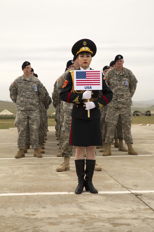 A Mongolian ceremony participant stands in front of U.S. Soldiers during the Khaan Quest 2016 opening ceremony May 22 at Five Hills Training Area, Ulaanbaatar, Mongolia. Khaan Quest 2016 is an annual multinational peacekeeping operations exercise conducted in Mongolia and is the capstone exercise for the Global Peace Operations Initiative. 