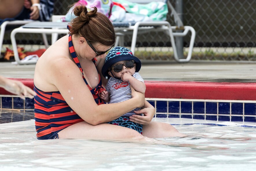 Carol and Nolan Espique, wife and son of U.S. Air Force Tech. Sgt. Edmon Espique, 23d Wing, relax in the pool during the “School’s Out Splash Party,” May 20, 2016, at Moody Air Force Base, Ga. The pool features a shallow end where young children can splash around or relax with parents. (U.S. Air Force Photo by Airman 1st Class Janiqua P. Robinson/Released)