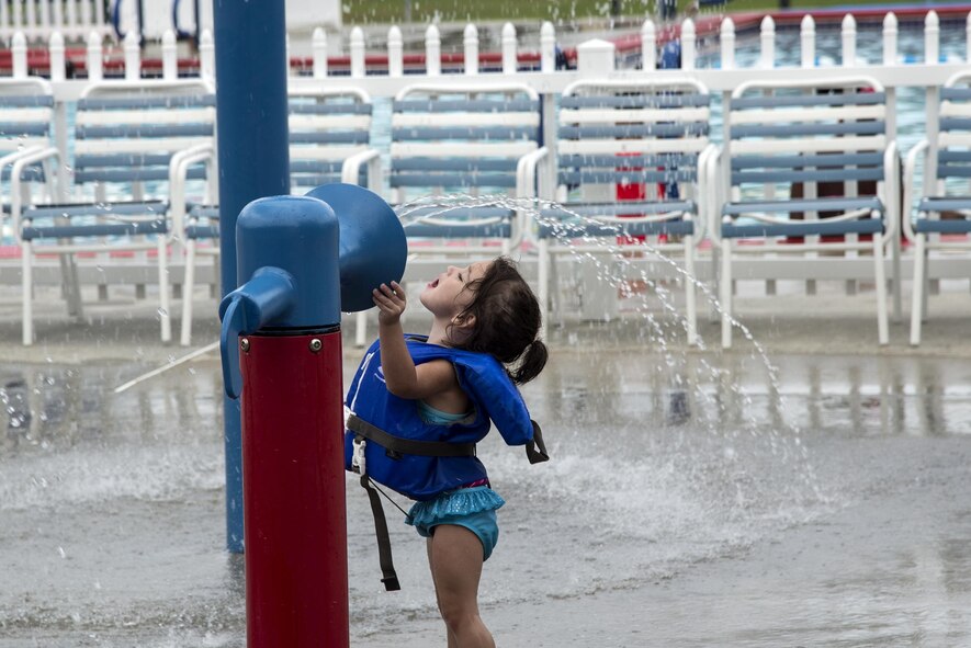 Zoe Munoz, daughter of Master Sgt. Alejandro Munoz, 723d Aircraft Maintenance Squadron, plays in the sprinklers during the “School’s Out Splash Party,” May 20, 2016, at Moody Air Force Base, Ga. The Outdoor Pool has a section featuring various sprinkler systems for children to enjoy. (U.S. Air Force Photo by Airman 1st Class Janiqua P. Robinson/Released)