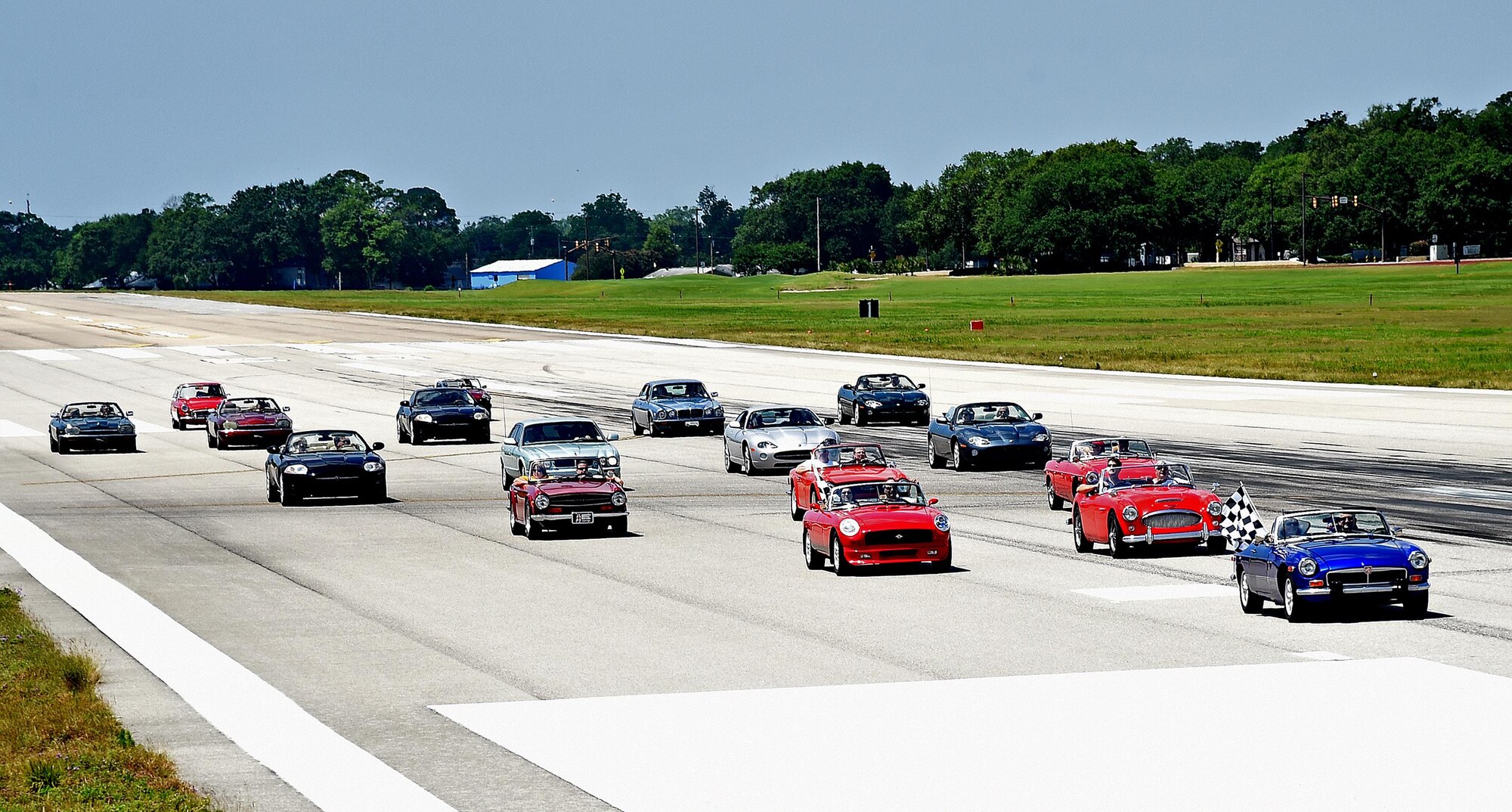 The British Car Club of New Orleans commemorated the Post World War II use of U.S. Air Force runways for auto racing by driving down the Keesler Air Force Base, Mississippi, runway May 21, 2016. In the Post-WWII era of early U.S. auto racing, there were several tragedies due to people racing on roadways. This mandated the move from road racing to tracks. However, before the tracks were ready, Gen. Curtis LeMay, a sports car enthusiast, allowed the use of U.S. Air Force runways at Strategic Air Command bases to the Sports Car Club of America for racing. The first two SCCA champions in 1951 and 1952 drove British sports cars. Lt. Col. Jeff Ragusa, 53rd Weather Reconnaissance Squadron pilot, helped organize the event. Ragusa and his wife Susan, are members of the British Car Club of New Orleans and own a 1974 MGB Roadster (Courtesy photo/Rich Kopp)
