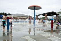 Children play in the sprinkler section of the outdoor pool during the “School’s Out Splash Party,” May 20, 2016, at Moody Air Force Base, Ga. The Outdoor Pool has a section featuring various sprinkler systems for children to enjoy. (U.S. Air Force Photo by Airman 1st Class Janiqua P. Robinson/Released)