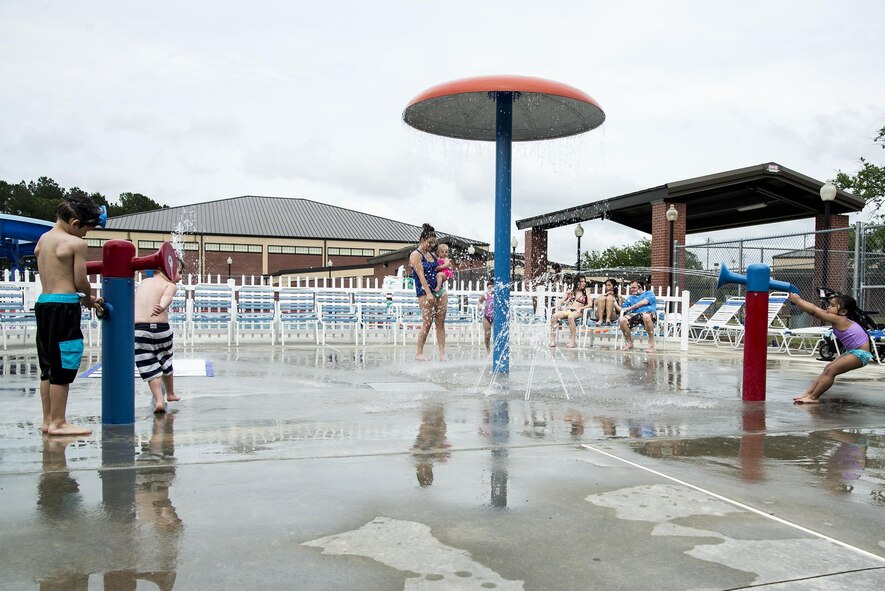 Children play in the sprinkler section of the outdoor pool during the “School’s Out Splash Party,” May 20, 2016, at Moody Air Force Base, Ga. The Outdoor Pool has a section featuring various sprinkler systems for children to enjoy. (U.S. Air Force Photo by Airman 1st Class Janiqua P. Robinson/Released)