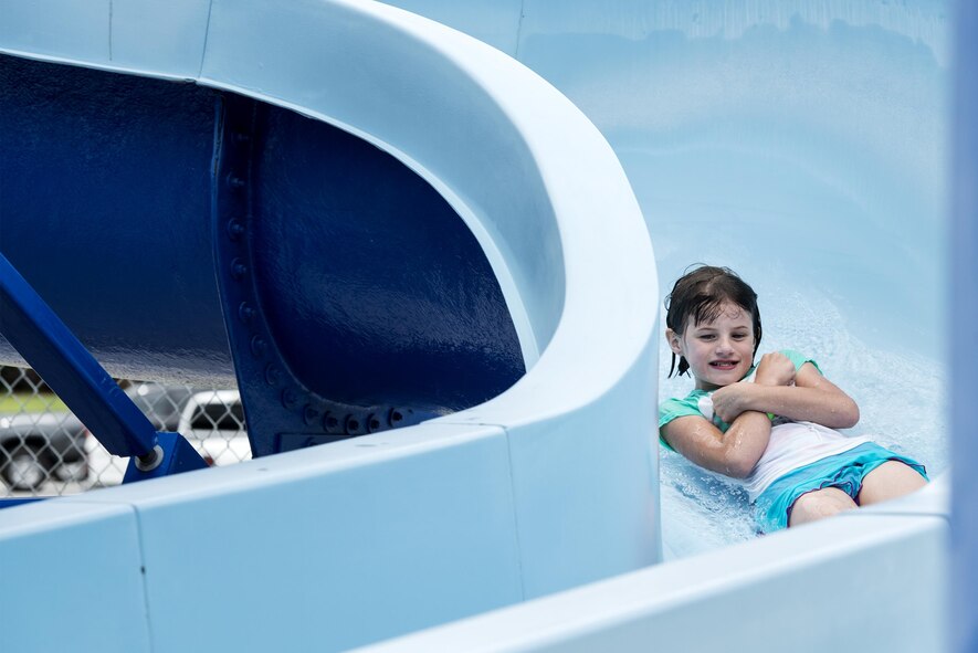 Rebekah White, daughter of U.S. Air Force Tech. Sgt. Aprille White, 23d Aerospace Medicine Squadron, rockets down a water slide during the “School’s Out Splash Party,” May 20, 2016, at Moody Air Force Base, Ga. The Outdoor Pool has a water slide that allows thrill seekers to plunge into water at an accelerated speed. (U.S. Air Force Photo by Airman 1st Class Janiqua P. Robinson/Released)