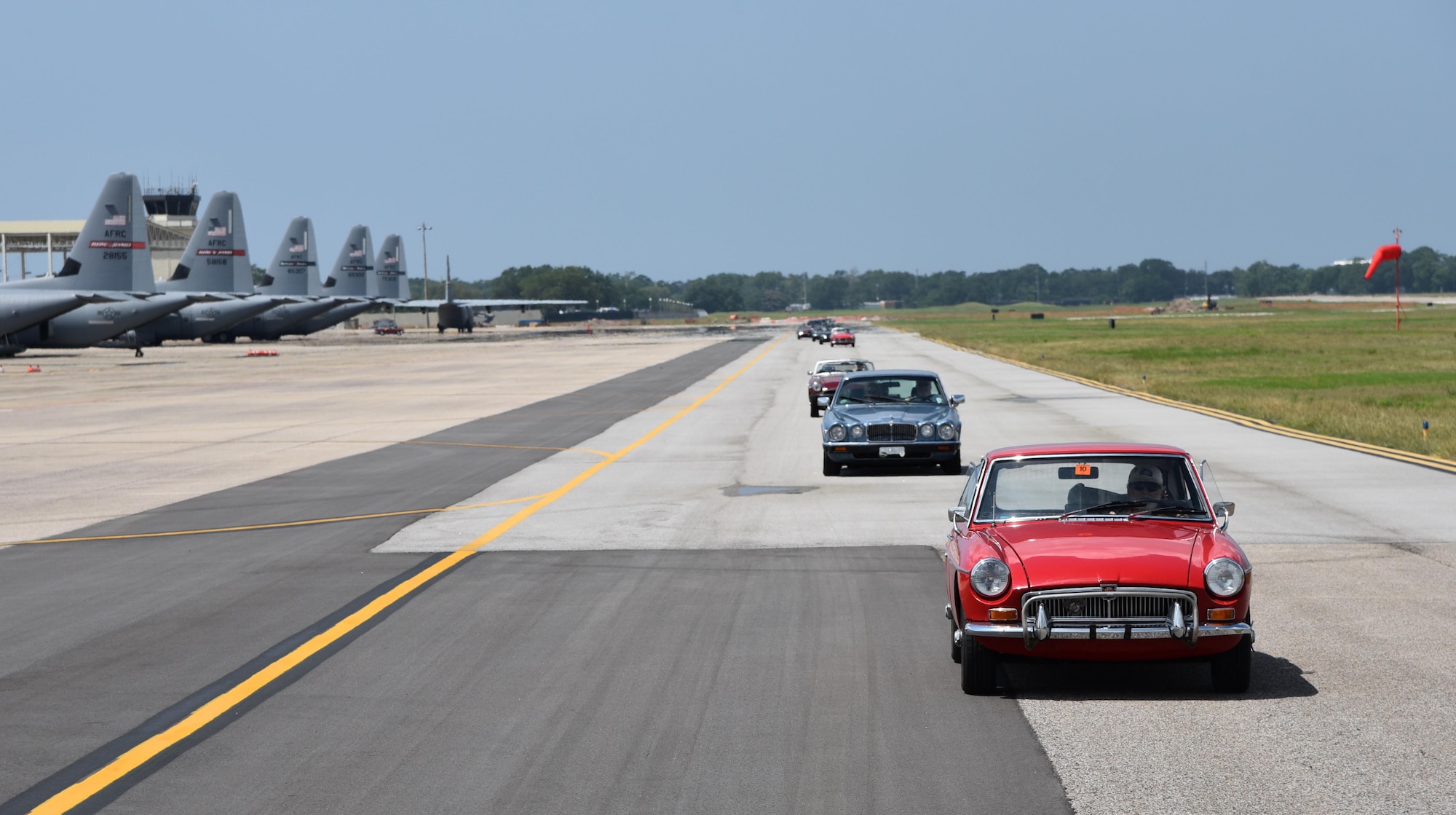 The British Car Club of New Orleans commemorated the Post World War II use of U.S. Air Force runways for auto racing by driving down the Keesler Air Force Base runway May 21, 2016. In the Post-WWII era of early U.S. auto racing, there were several tragedies due to people racing on roadways. This mandated the move from road racing to tracks. However, before the tracks were ready, Gen. Curtis LeMay, a sports car enthusiast, allowed the use of U.S. Air Force runways at Strategic Air Command bases to the Sports Car Club of America for racing. The first two SCCA champions in 1951 and 1952 drove British sports cars. Lt. Col. Jeff Ragusa, 53rd Weather Reconnaissance Squadron pilot, helped organize the event. Ragusa and his wife Susan, are members of the British Car Club of New Orleans and own a 1974 MGB Roadster. (U.S. Air Force photo/Maj. Marnee A.C. Losurdo)