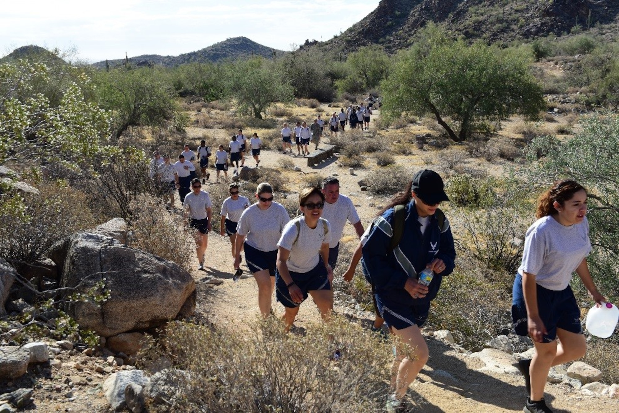 Airmen from the 944th Force Support Squadron participate in a hike at White Tank Mountain Regional Park, Ariz. April 29, 2016. A total of 48 Airmen, including two medics, participated in the hike to promote fitness and boost morale. The unit also wanted to take advantage of the 3-day Unit Training Assembly by doing an outdoor team building activity before the “intense summer heat arrives” according to Maj. Sheilia Kane, 944th FSS operations officer. (U.S. Air Force photo by Staff Sgt. Lausanne Kinder)
