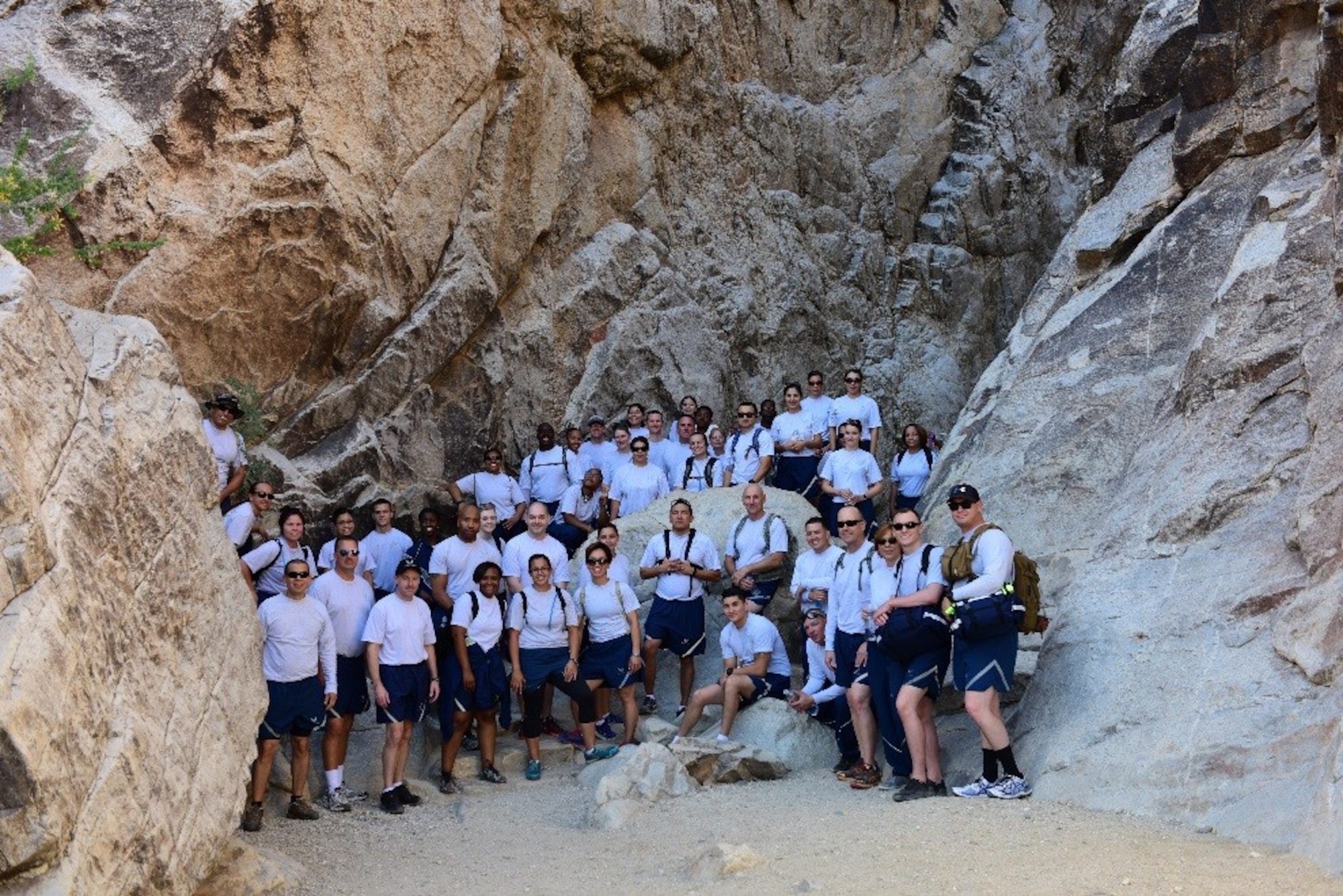 Airmen from the 944th Force Support Squadron pose for a photo during a hike at White Tank Mountain Regional Park, Ariz. April 29, 2016. A total of 48 Airmen, including two medics, participated in the hike to promote fitness and boost morale. The unit also wanted to take advantage of the 3-day Unit Training Assembly by doing an outdoor team building activity before the “intense summer heat arrives” according to Maj. Sheilia Kane, 944th FSS operations officer. (U.S. Air Force photo by Staff Sgt. Lausanne Kinder)