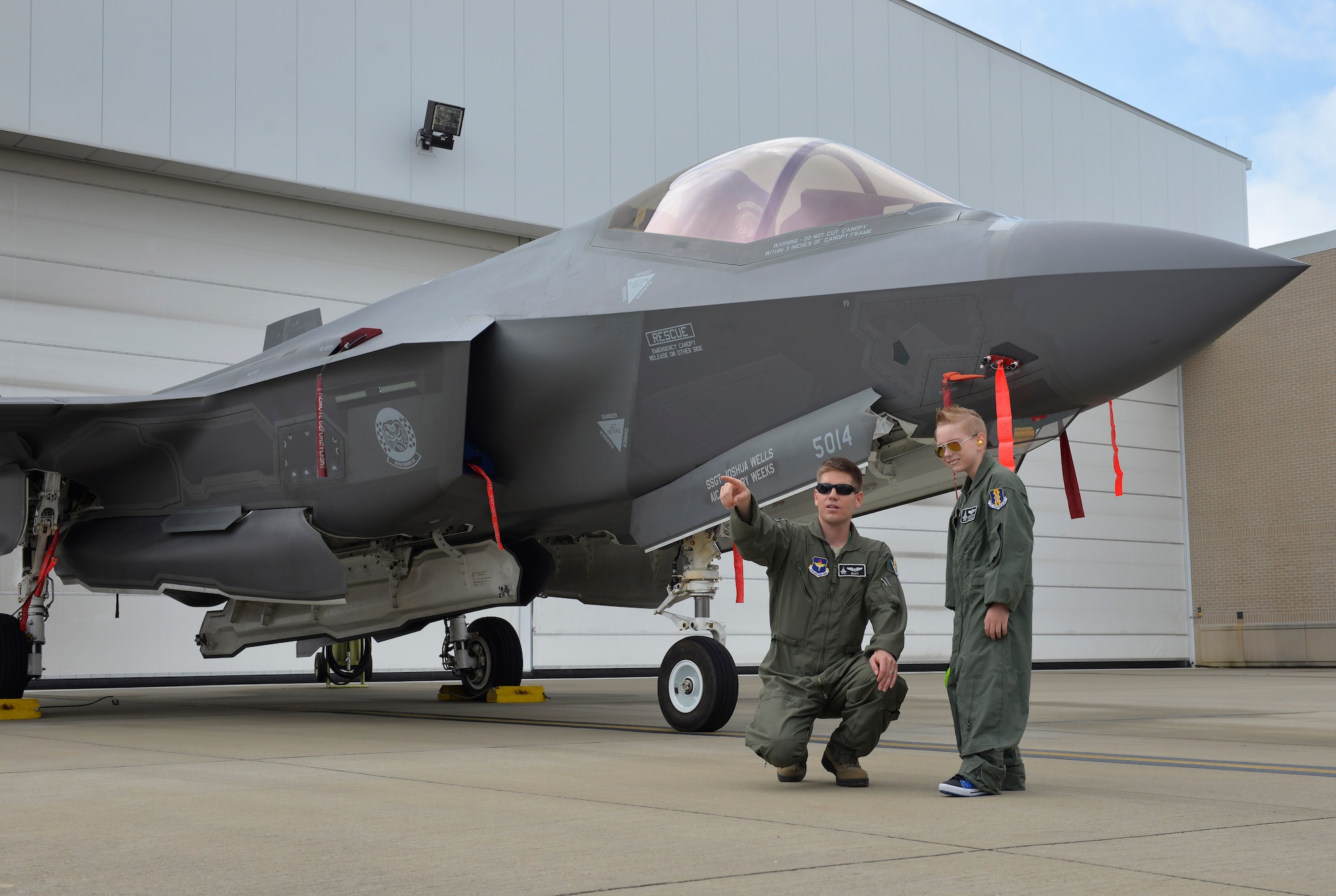 Maj. Mike Krestyn, 33rd Operations Support Squadron chief of scheduling, talks with Pilot for a Day, Christian Loafman, about the F-35A Lightning II at Eglin Air Force Base, Fla., May 18, 2016. The Pilot for a Day program is a new initiative for the 33rd Fighter Wing that gives children the opportunity to experience what it’s like to be an F-35A pilot. (U.S. Air Force photo/Senior Airman Andrea Posey)