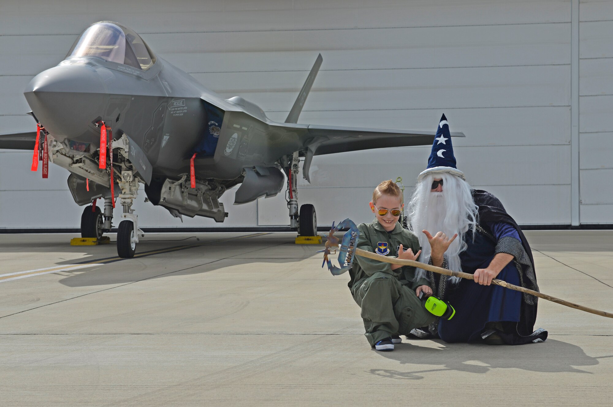 The 33rd Maintenance Squadron’s wizard mascot kneels in front of an F-35A Lightning II with Pilot for a Day, Christian Loafman, whose name was placed on the aircraft at Eglin Air Force Base, Fla., May 18, 2016. During his visit, Christian was greeted by military members dressed as superheroes who guided him through the maintenance portion of his tour. (U.S. Air Force photo/Senior Airman Andrea Posey)