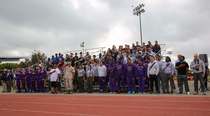 Participants in the National High School Physical Fitness Championships honor the colors during the opening ceremony at Marine Corps Recruit Depot San Diego, May 20. The event is sponsored by the United States Marines Youth Foundation, Inc. and is a five-event competition consisting of sit-ups, push-ups, broad jump, pull-ups and a shuttle run. High school students from across the country competed in local and state competitions before making it the championships at the depot.