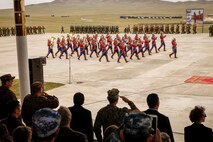 The ceremonial band from the Mongolian Armed Forces salute distinguished visitors and the President of Mongolia Tsakhiagiin Elbegdorj, during the opening ceremony for Khaan Quest 2016, at Five Hills Training Area, Mongolia, May 22, 2016. Khaan Quest is an annual, multinational peacekeeping operations exercise conducted in Mongolia and is the capstone exercise for this year's United Nations Global Peace Operations Initiative program. 