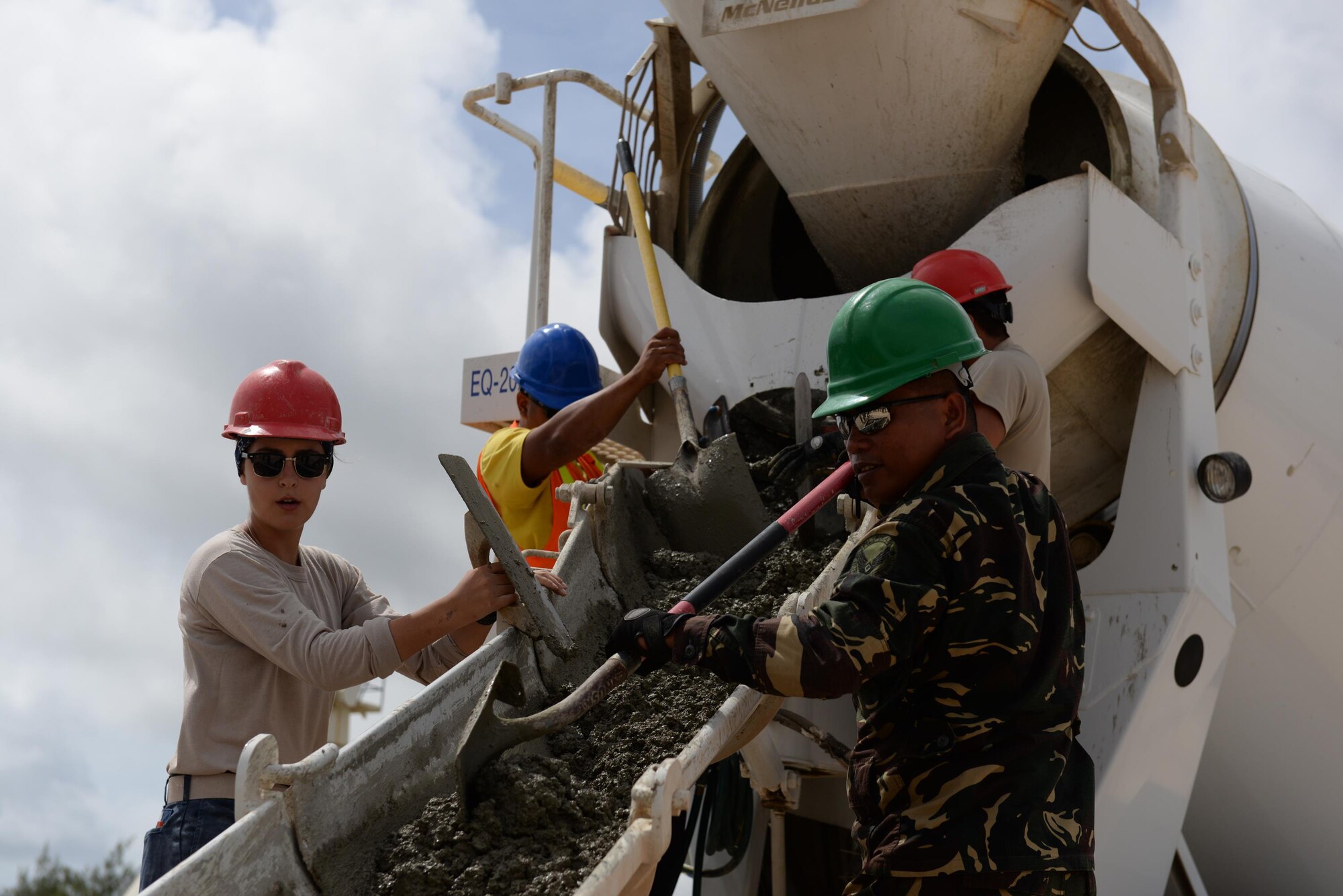 U.S. and Philippine Airmen push concrete from a cement truck during a Pacific Unity tilt-up workshop May 18, 2016, at Andersen Air Force Base, Guam. Pacific Unity events are designed to build partnerships and promote interoperability through the equitable exchange of civil engineer related information. (U.S. Air Force photo by Airman 1st Class Jacob Skovo)