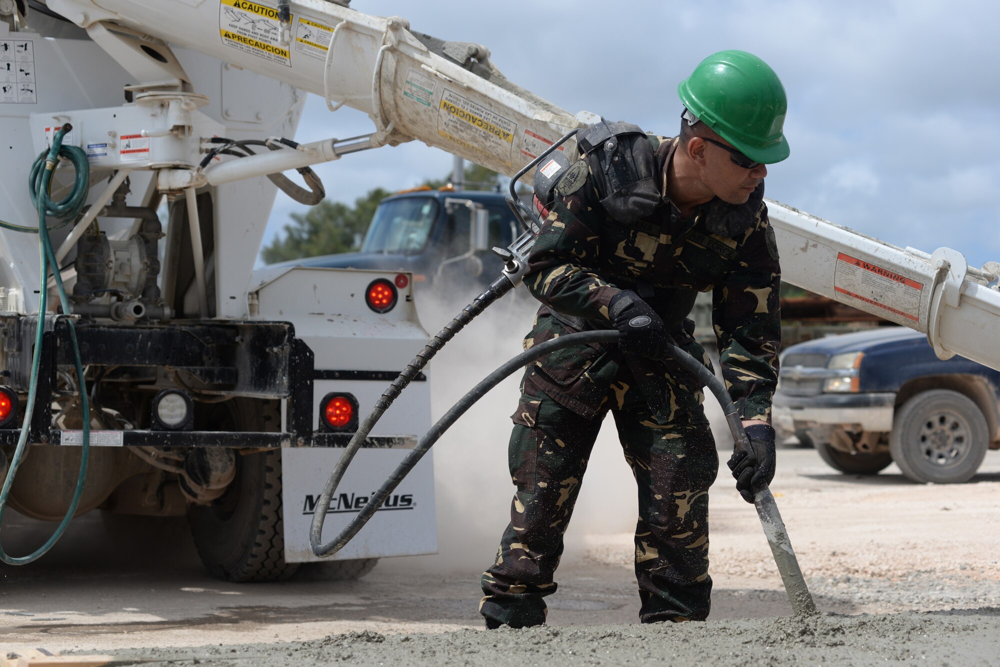 Philippine air force Sgt. Jufrey Laplana, Air Force Chief of Engineers Office NCO in charge of plans and programs, vibrates concrete to settle it in the form during a tilt-up workshop May 18, 2016, at Andersen Air Force Base, Guam. The Pacific Unity 16-1 tilt-up workshop is a Pacific Air Forces-led engagement focusing on a series of civil engineering subject-matter expert exchanges designed to increase partner capabilities, military relations and regional stability for the Indo-Asia-Pacific region. (U.S. Air Force photo by Airman 1st Class Jacob Skovo)