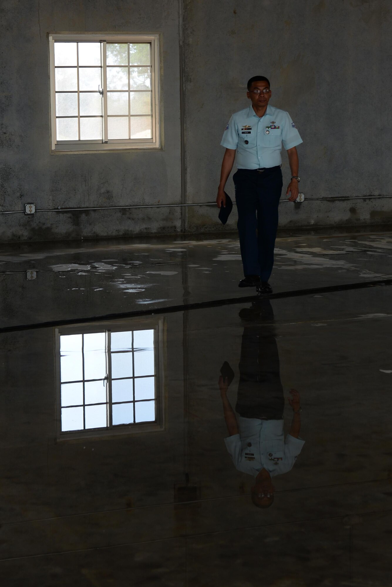 Philippine air force Staff Sgt. Generex Sazon, Air Force Chief of Engineers Office NCO in charge, tours a warehouse under construction at the Pacific Regional Training Center during a Pacific Unity event May 10, 2016, at Andersen Air Force Base, Guam. The Pacific Unity 16-1 tilt-up workshop is a Pacific Air Forces-led engagement focusing on a series of civil engineering subject-matter expert exchanges designed to increase partner capabilities, military relations and regional stability for the Indo-Asia-Pacific region. (U.S. Air Force photo by Airman 1st Class Jacob Skovo)