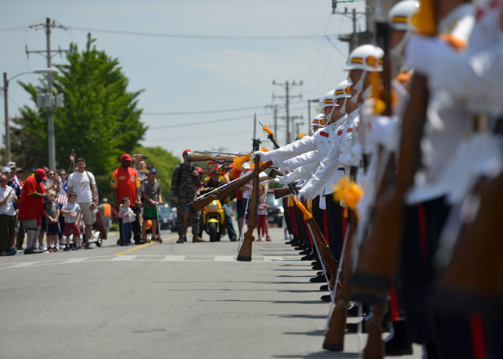 The Republic of Korea marine corps drill team perform a rifle movement during a demonstration at the Armed Forces Day Parade, Osan Air Base, Republic of Korea, May 21, 2016. The drill team put on the demonstration at the end of the parade, which was hosted by the local Veterans of Foreign Wars, Post 10216. (U.S. Air Force photo by Senior Airman Victor J. Caputo/Released)
