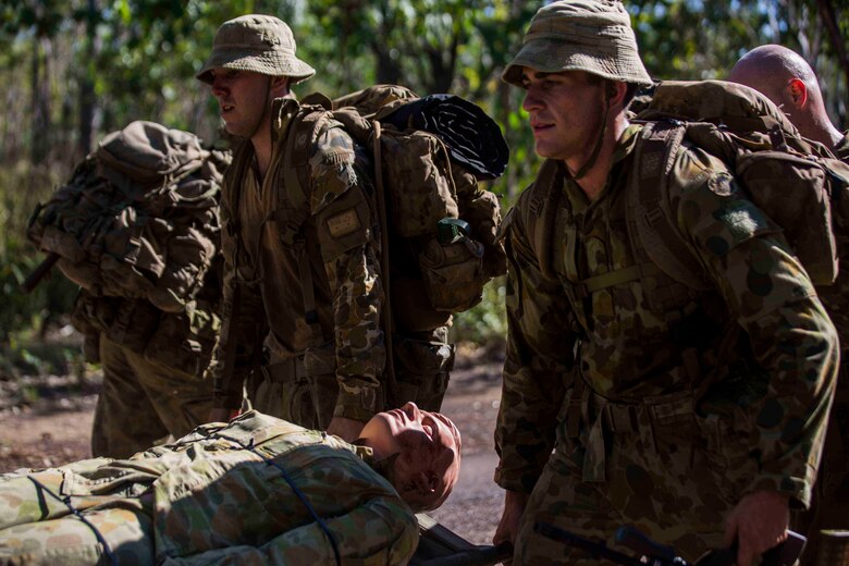 Members of the Australian Army with 5th Battalion, Royal Australian Regiment, simulate the transportation of a casualty victim outside Robertson Barracks, Darwin, Australia, May 12, 2016 U.S. Marines worked together with the Australian service members during Subject One for Corporal Class #0245. Experiencing Subject One for Corporal Class #0245 together allows everyone to train and learn from each other during Marine Rotational Force – Darwin (MRF-D). MRF-D is a six-month deployment of Marines into Darwin, Australia, where they will conduct exercises and train with the Australian Defence Forces, strengthening the U.S.-Australia alliance.