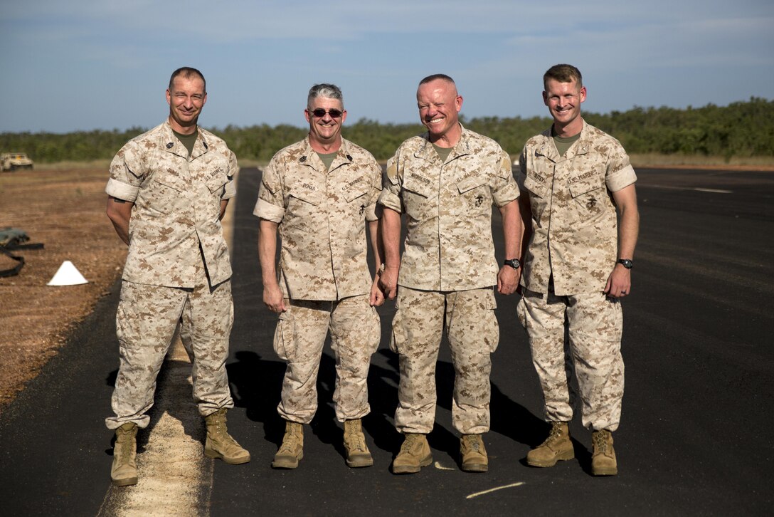 Marines from left to right, Sgt. Maj. Stuart D. Glass, 1st Battalion, 1st Marine Regiment Sergeant Major, Sgt. Maj. Lee D. Bonar Jr., III Marine Expeditionary Force Sergeant Major, Lt. Gen. Lawrence D. Nicholson, III MEF Commanding General, and Lt. Col. Steven M. Sutey, 1st Battalion, 1st Marine Regiment Commanding Officer, smile for a photo at Mount Bundey Airfield, Northern Territory, Australia, on May 11, 2016. Nicholson visited Marines with Marine Rotational Force – Darwin’s Aviation Combat Element at a forward arming and refueling point.