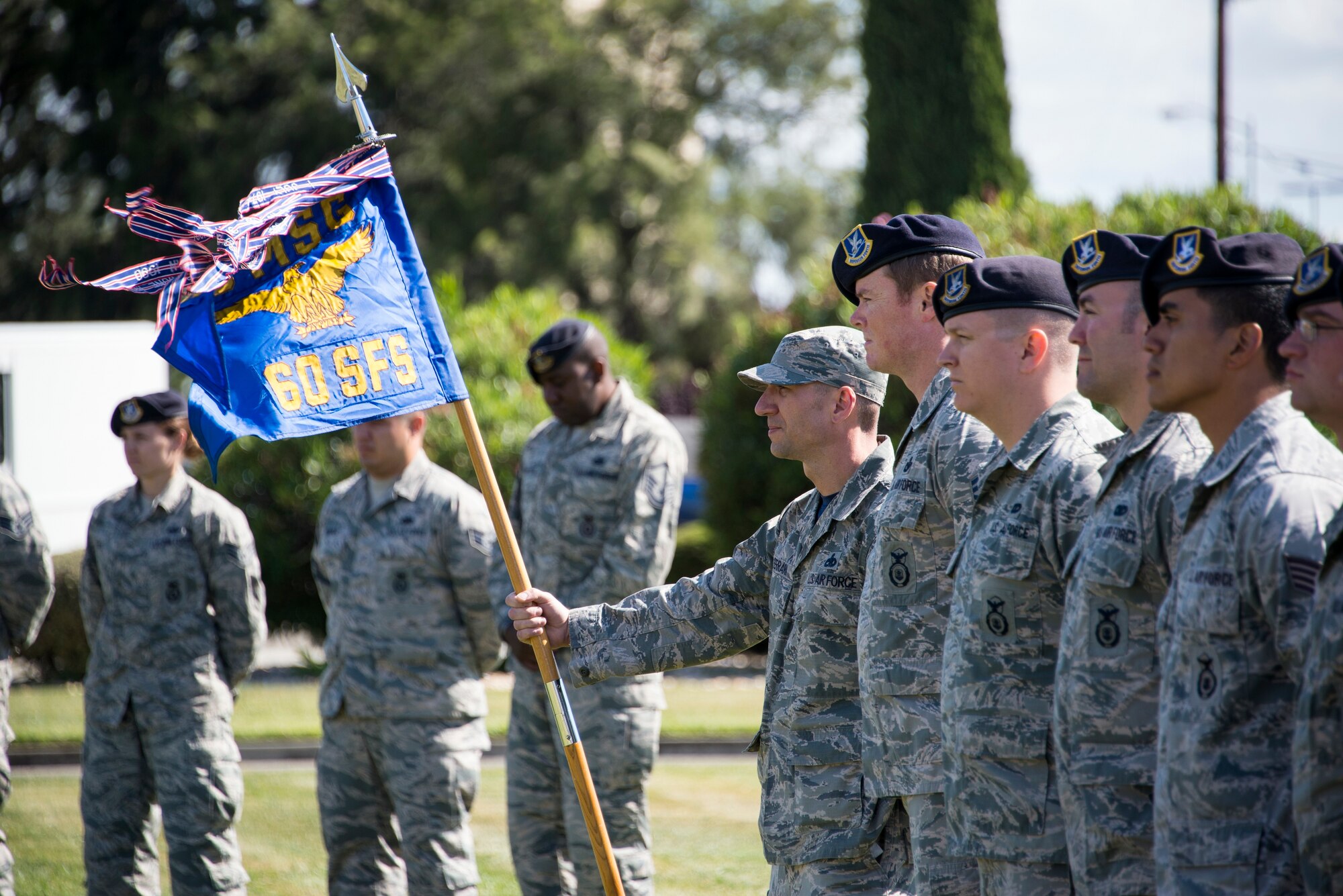 Master Sgt. Jesse Ferrari, 60th Security Forces Squadron first sergeant, holds the unit guideon during a retreat ceremony at Travis Air Force Base, Calif., May 20, 2016. The retreat ceremony concluded a week of activities hosted by base security forces personnel as part of National Police Week. (U.S. Air Force photo by Staff Sgt. Charles Rivezzo)
