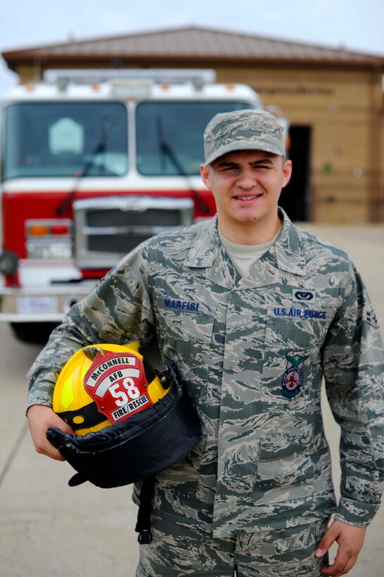 Airman 1st Class Donald Marfisi, 22nd Civil Engineer Squadron firefighter, poses in front of his assigned firetruck, May 19, 2016, at McConnell Air Force Base, Kan. Marfisi was recently part of an Airmen Exchange Program, where he partnered with an Airmen from different Air Force Specialty Code where he shadowed their job for a day. (U.S. Air Force photo/Airman 1st Class Jenna K. Caldwell)