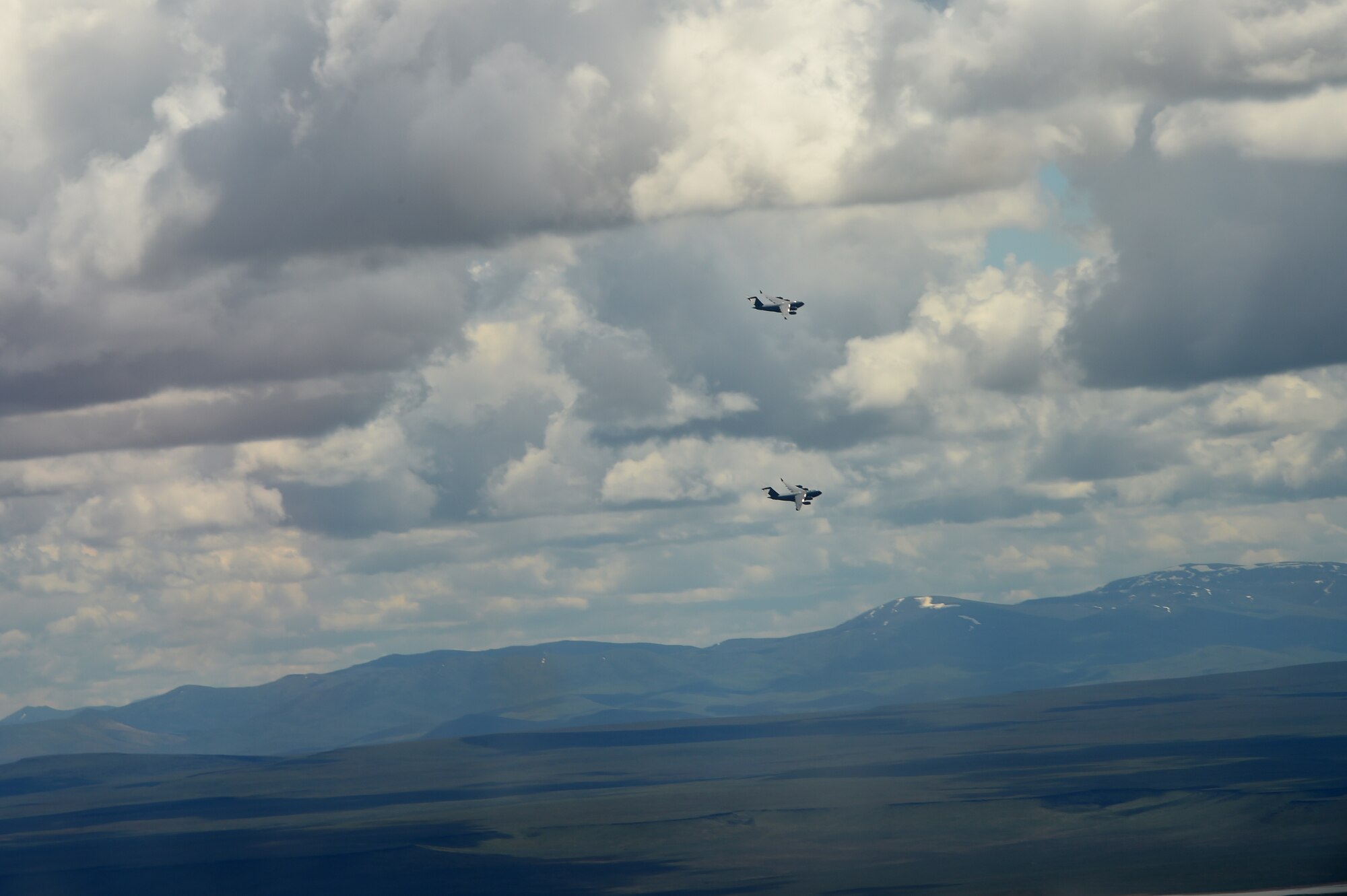 Two McChord C-17 Globemaster IIIs fly over the Mountain Home Range Complex, Idaho, May 17, 2016. The McChord tails were two of seven C-17s working with F-15 Strike Eagles C-17s in training as part of a Large Force Exercise at the Mountain Home Range Complex in preparation for Air Mobility Command’s next generation exercise Mobility Guardian. (U.S. Air Force photo/Staff Sgt. Naomi Shipley)