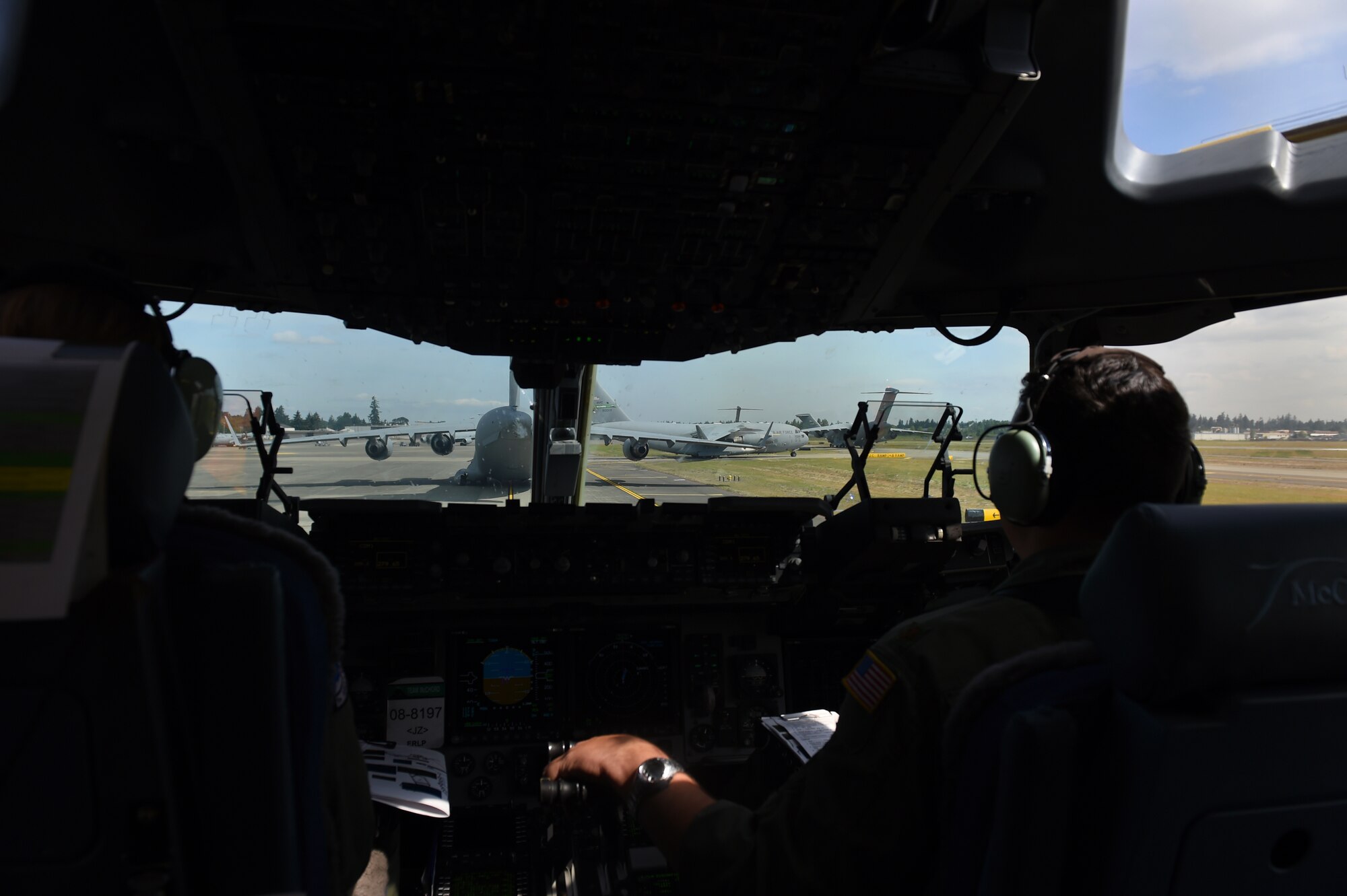 Seven C-17 Globemaster IIIs prepare to depart the McChord Field flight line May 17, 2016, to conduct air land and air drop operations as part of a Large Force Exercise at the Mountain Home Range Complex, Idaho. Mountain Home F-15 Strike Eagles provided a detached escort and reactive close air support, a first for McChord local training missions. (U.S. Air Force photo/Staff Sgt. Naomi Shipley)