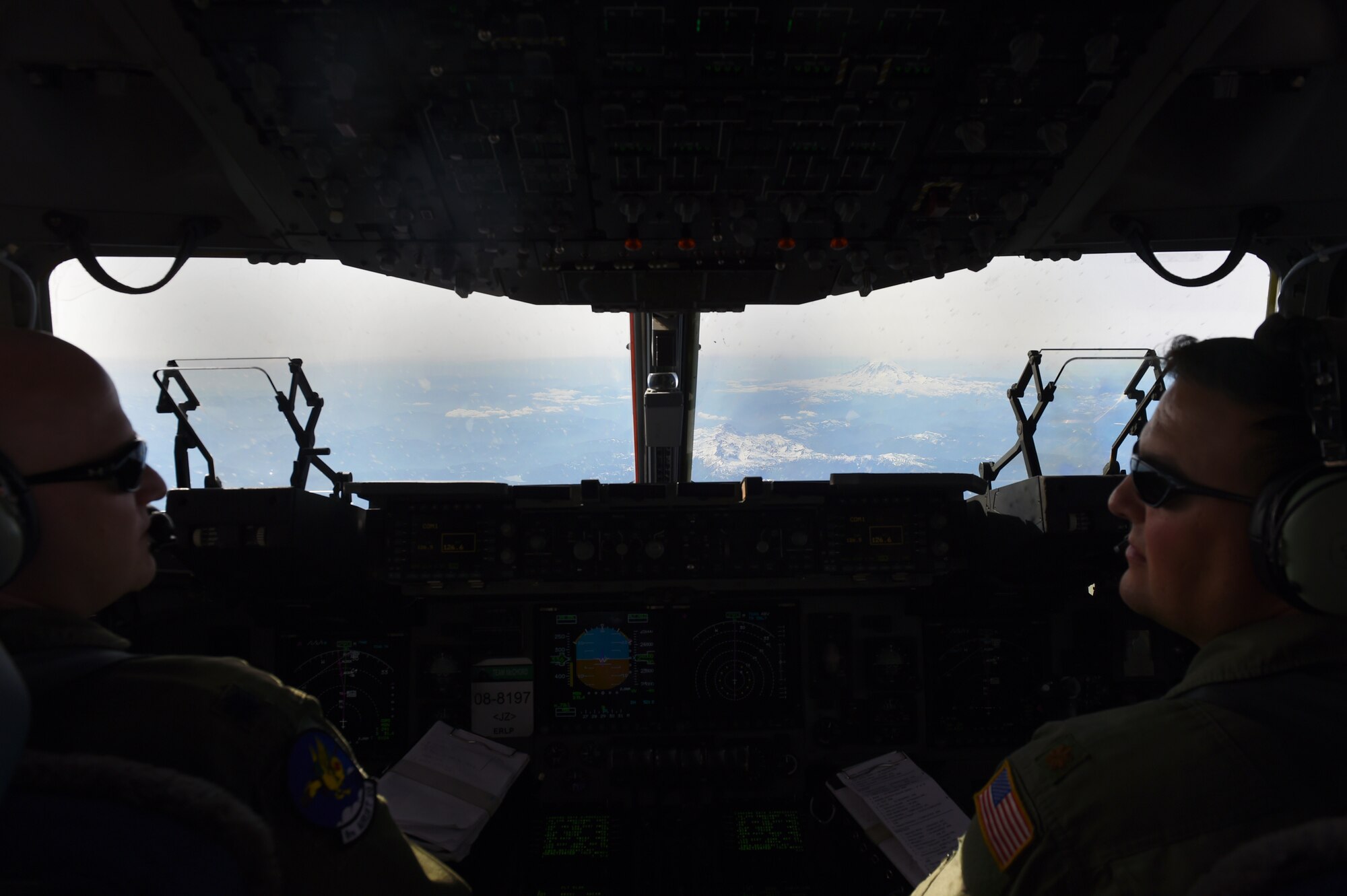Lt. Col. Brian Smith (left), 62nd Operation Group Deputy Commander, and Maj. Jack Vetas, 8th Airlift Squadron C-17 pilot, fly a C-17 Globemaster III over the Mountain Home Range Complex, Idaho, May 17, 2016. The two pilots were part of six other McChord air crews exercising the proof of concept for Air Mobility Command’s next generation exercise. (Mobility Guardian (U.S. Air Force photo/Staff Sgt. Naomi Shipley)