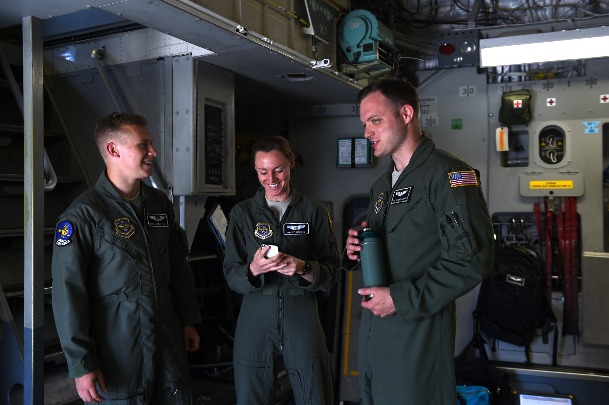 (From Left) Airman 1st Class Jeremy Kosick, A1C Jacob Lueck 8th Airlift Squadron loadmasters and 1st Lt. Kaley Jenkins, 8 AS C-17 pilot, talk inside a C-17 Globemaster III May 17, 2016, at Mountain Home Air Force Base, Idaho. The McChord air crew flew to the mountain home range to train in a simulated hostile environment with F-15 Strike Eagles. (U.S. Air Force photo/Staff Sgt. Naomi Shipley)
