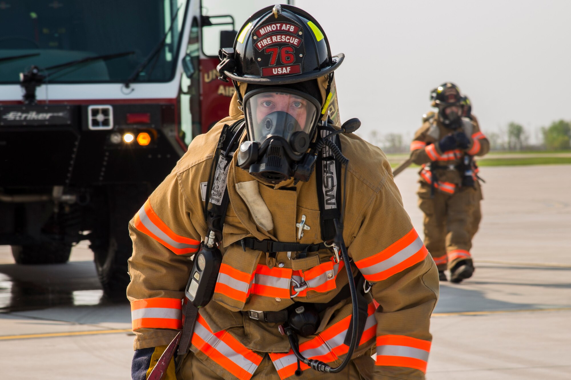 A 5th Civil Engineer Squadron firefighter approaches a smoking aircraft during a simulation at Minot Air Force Base, N.D., May 19, 2016. The Minot AFB fire department train and perform exercises regularly to maintain readiness. (U.S. Air Force photo/Airman 1st Class Christian Sullivan)