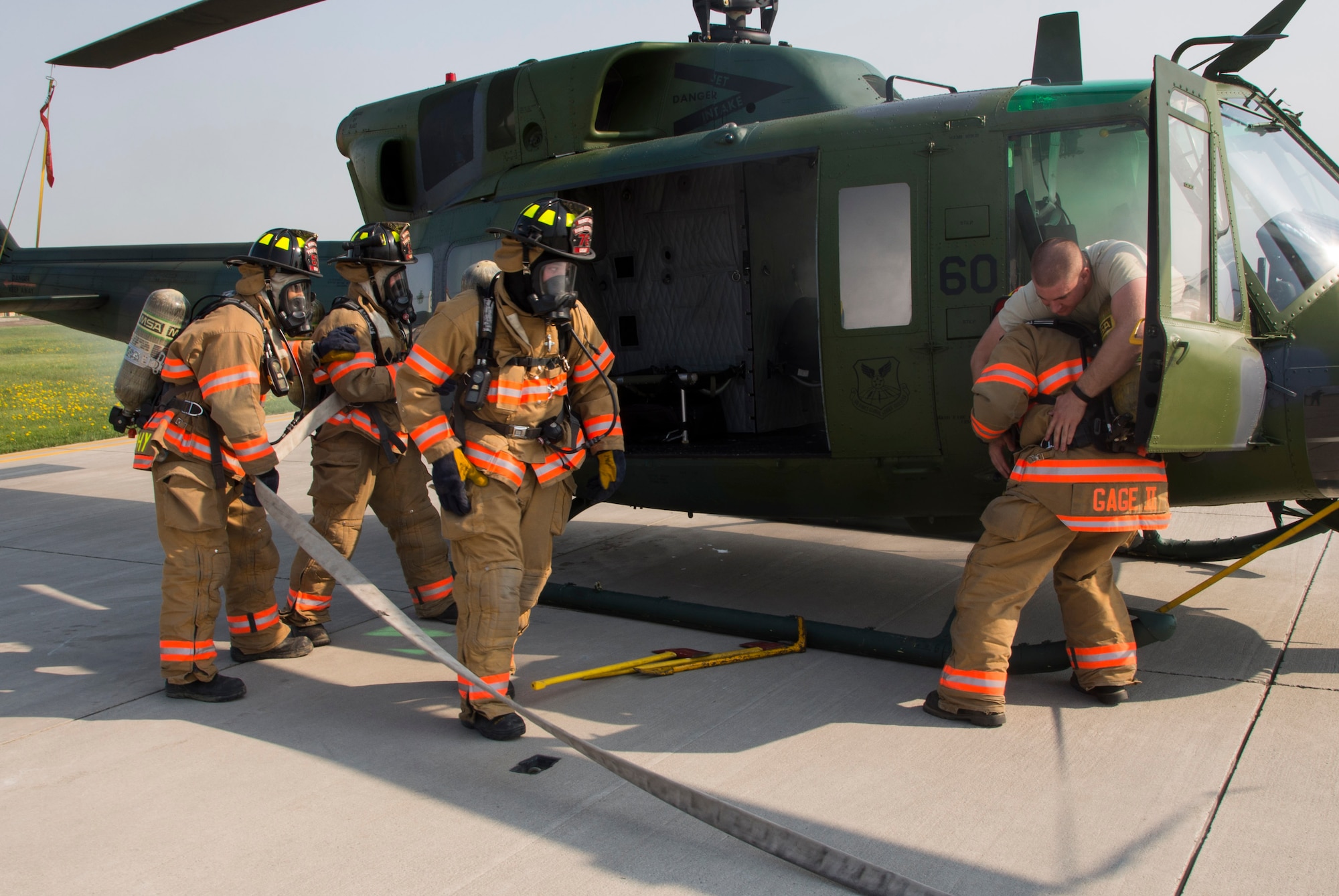 Firefighters from the 5th Civil Engineer Squadron “rescue” an Airman from a smoking aircraft during a simulation at Minot Air Force Base, N.D., May 19, 2016. The Minot AFB fire department train and perform exercises regularly to maintain readiness. (U.S. Air Force photo/Airman 1st Class Christian Sullivan)