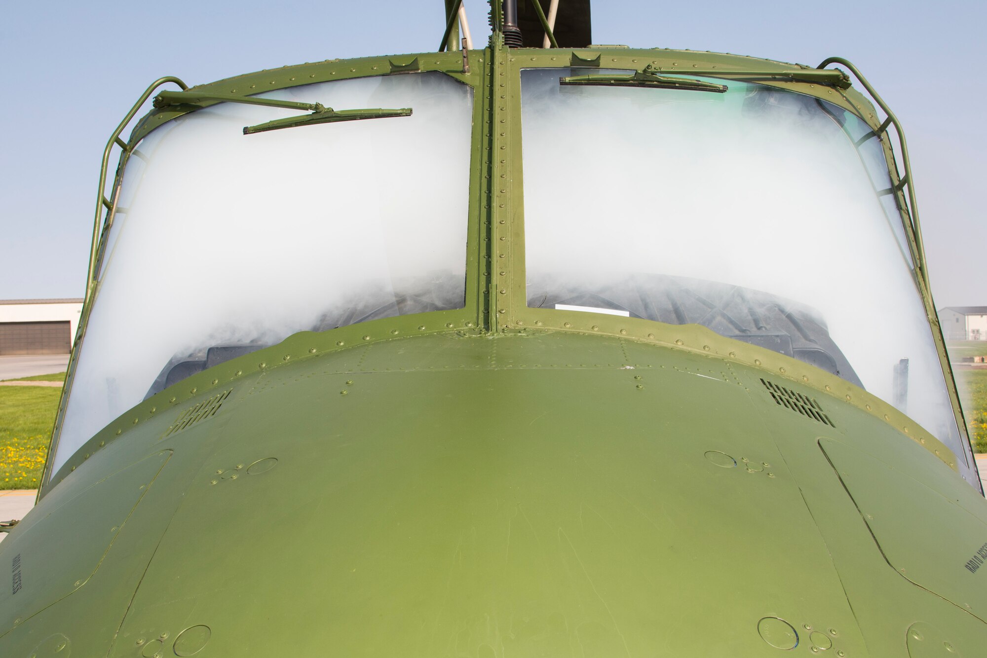 A UH-1N Huey fills with smoke as the 5th Civil Engineer Squadron firefighters prepare for a simulation at Minot Air Force Base, N.D., May 19, 2016. The Minot AFB fire department train and perform exercises regularly to maintain readiness. (U.S. Air Force photo/Airman 1st Class Christian Sullivan)