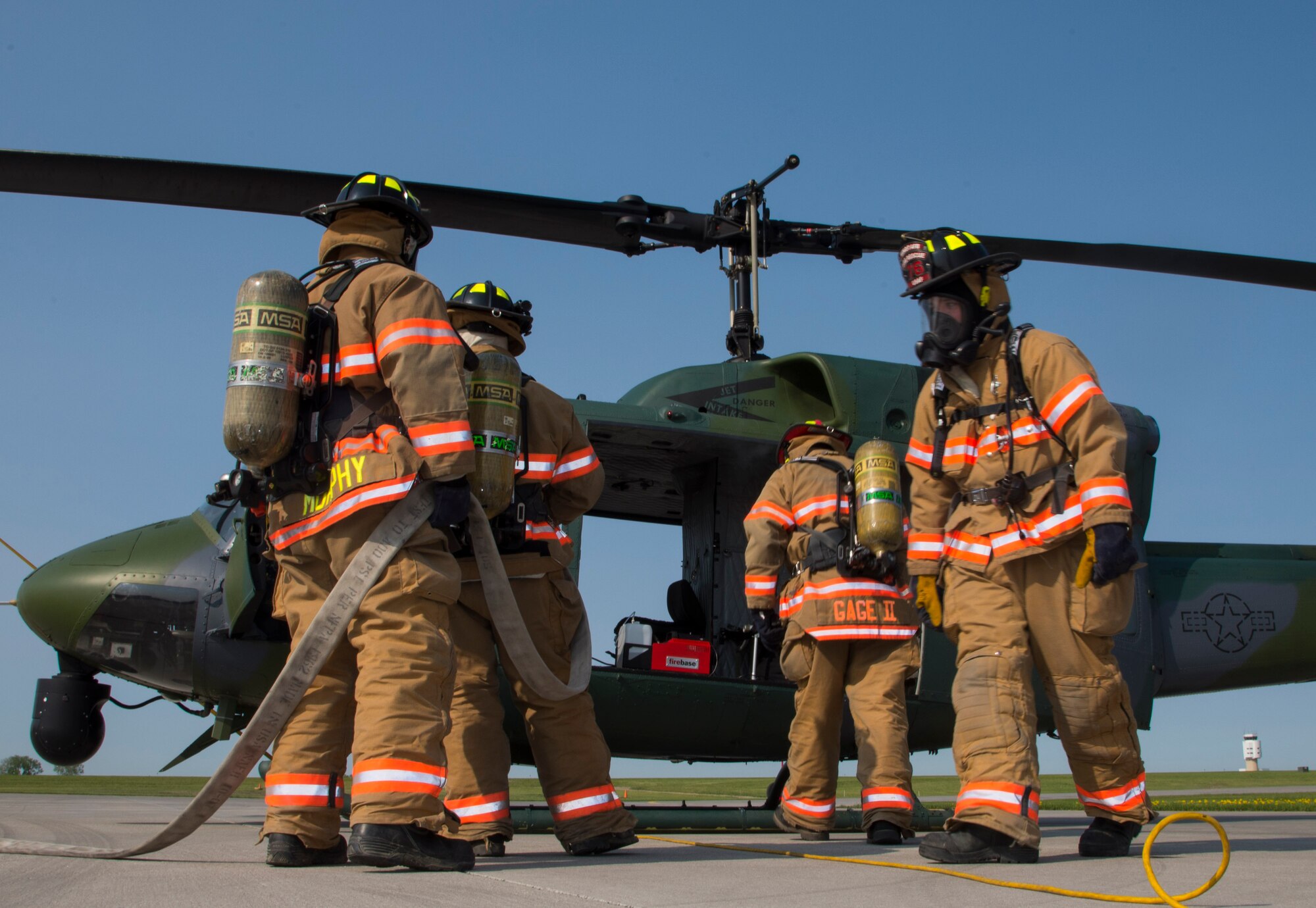 5th Civil Engineer Squadron firefighters wait for the smoke to clear out before checking an aircraft during a simulation at Minot Air Force Base, N.D., May, 19, 2016. The Minot AFB fire department train and perform exercises regularly to maintain readiness. (U.S. Air Force photo/Airman 1st Class Christian Sullivan)