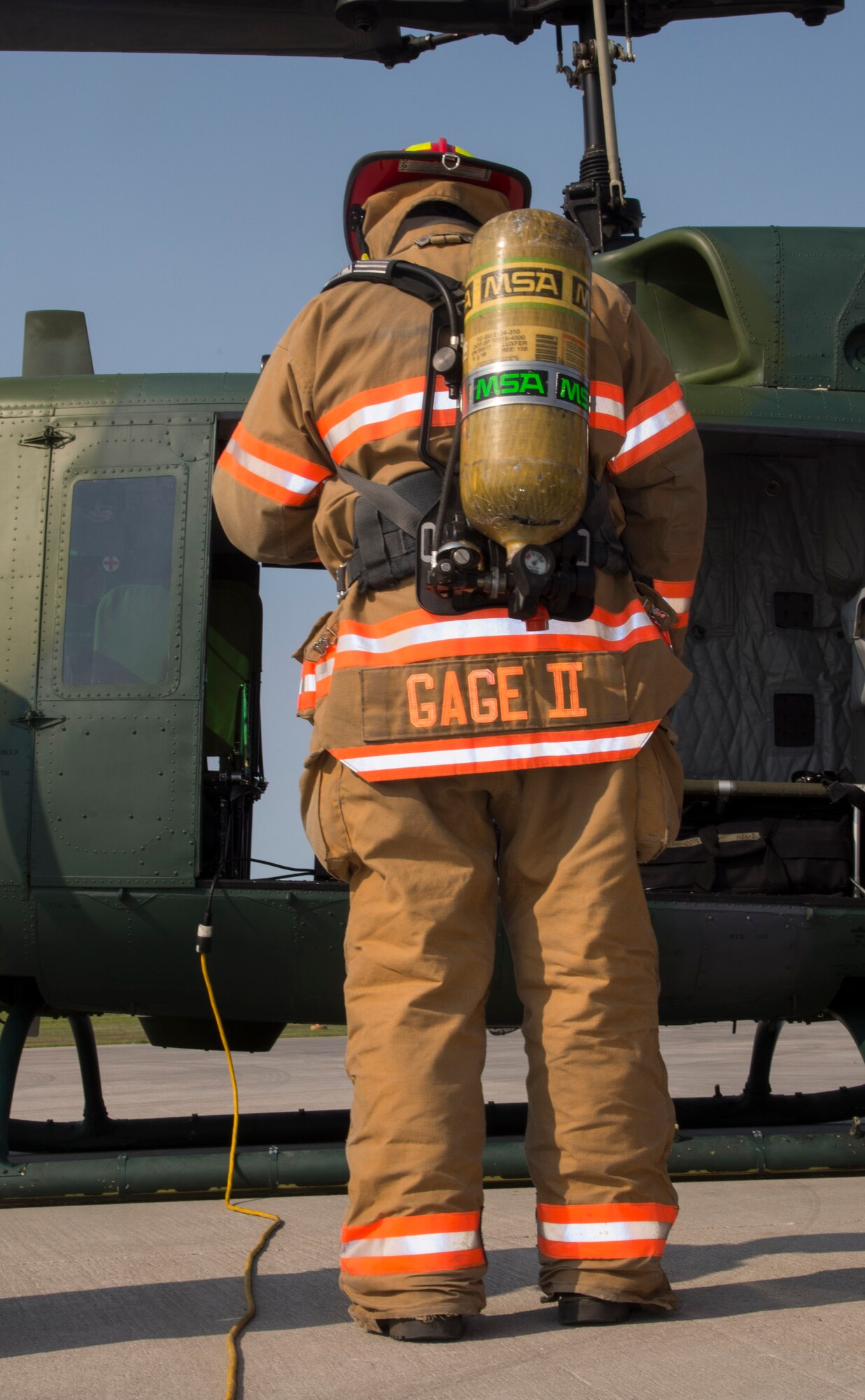 Charles Gage II, 5th Civil Engineer Squadron firefighter, waits for the smoke to clear out before checking an aircraft during a simulation at Minot Air Force Base, N.D., May, 19, 2016. The Minot AFB fire department train and perform exercises regularly to maintain readiness. (U.S. Air Force photo/Airman 1st Class Christian Sullivan)