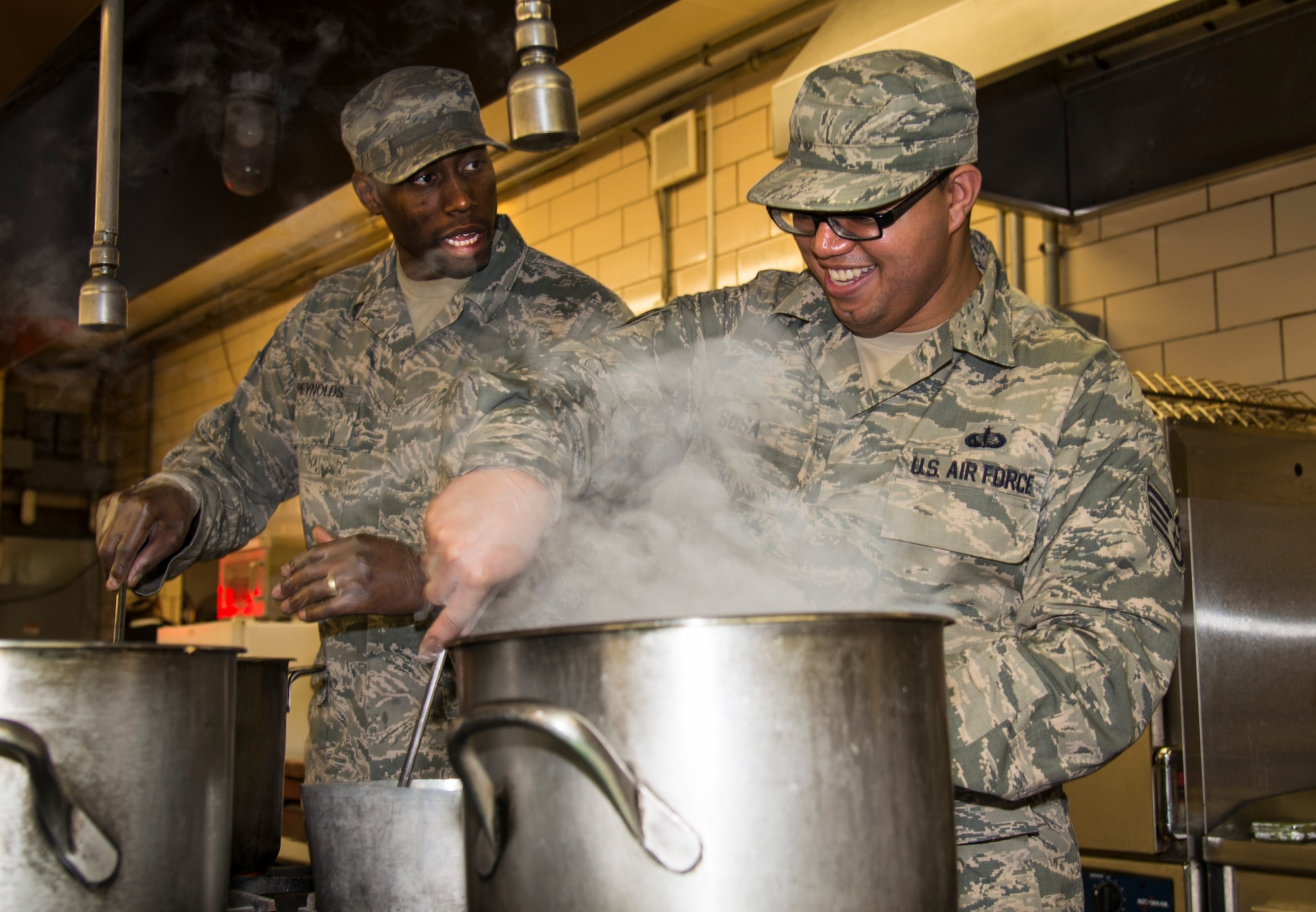 Staff Sgt. Jeremy Reynolds, 5th Force Support Squadron member, talks to his teammate during the top chef competition at Minot Air Force Base, N.D., May 17, 2016. Three teams consisting of Minot chefs and at least one missile chef competed to go to Barksdale AFB, L.A. for the Global Strike Competition. (U.S. Air Force photo/Airman 1st Class Christian Sullivan)