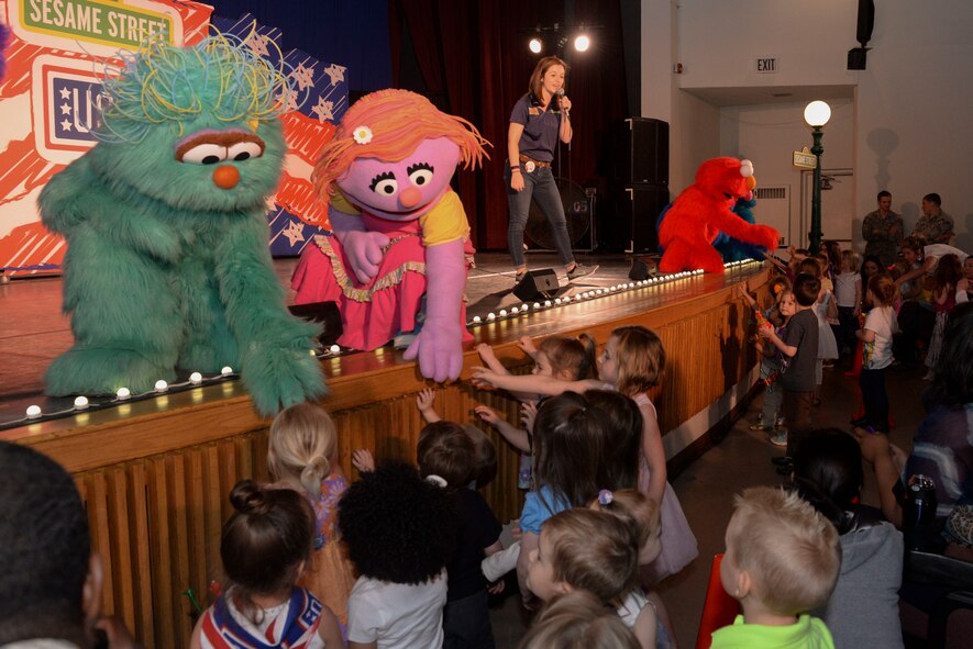 Rosita, left, and Elmo, far right, characters from Sesame Street visit with children at the base theater at Minot Air Force Base, N.D., for the first stop in the stateside Experience for Military Families tour sponsored by the USO and Sesame Street. This special performance was about military-to-civilian transition about young children in military families adapting to a new base or adapting to a new lifestyle. (U.S. Air Force photo/Airman 1st Class Jessica Weissman) 